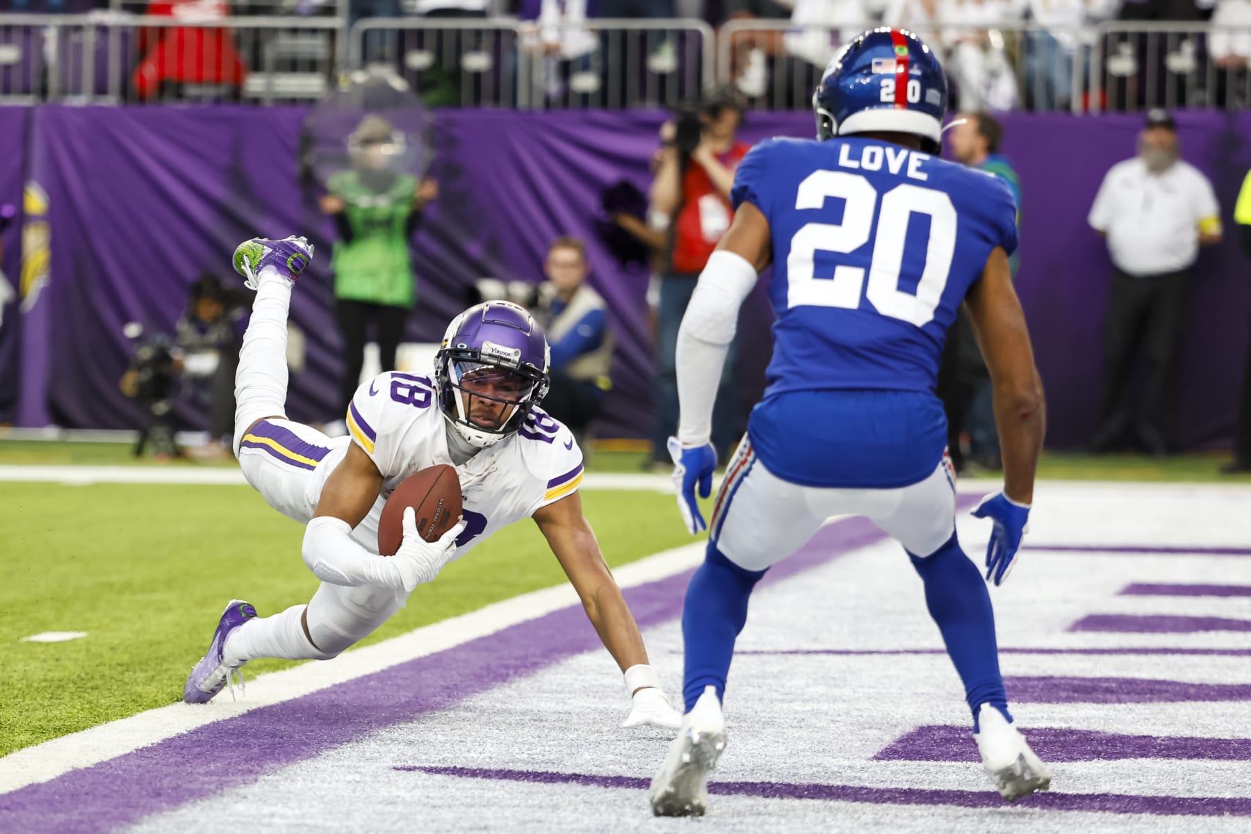 MINNEAPOLIS, MN - DECEMBER 24: Justin Jefferson #18 of the Minnesota Vikings dives for a landing whereas Julian Worship #20 of the Sleek York Giants defends in the fourth quarter of the game at U.S. Bank Stadium on December 24, 2022 in Minneapolis, Minnesota. The Vikings defeated the Giants 27-24. (Photo by David Berding/Getty Photos)