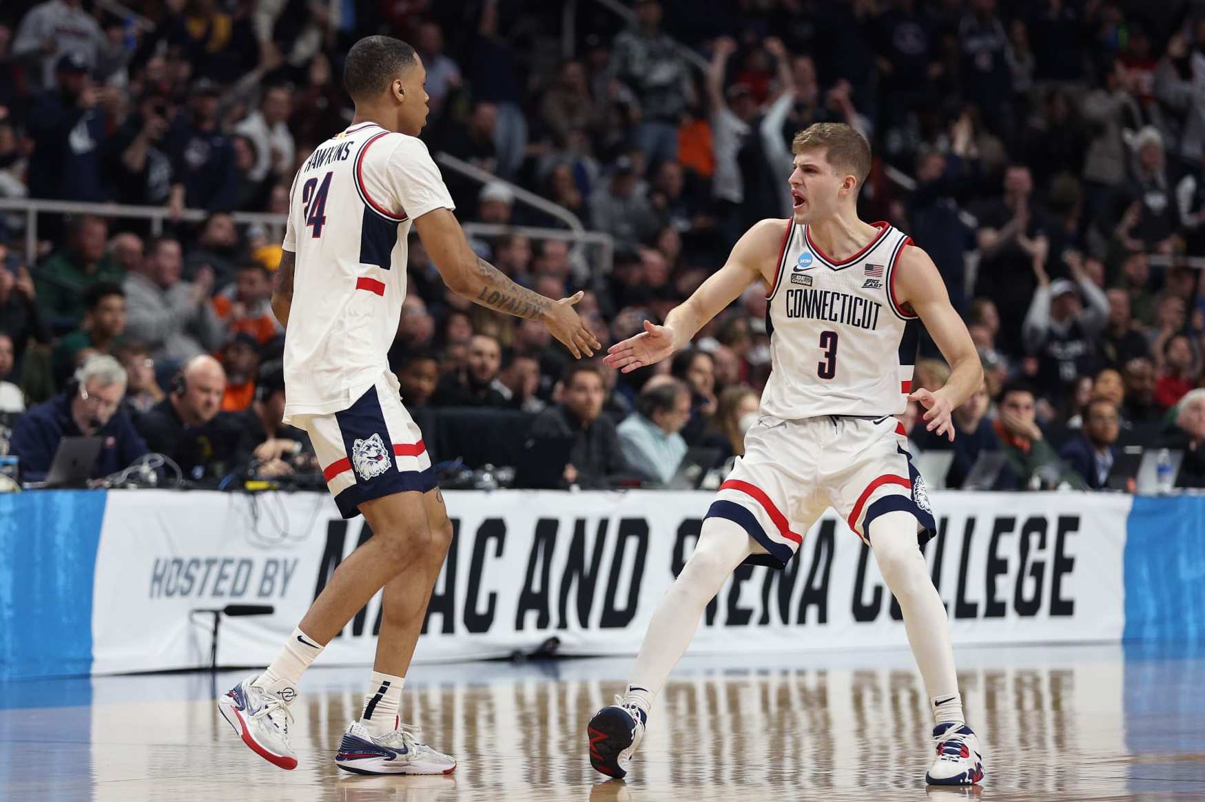 ALBANY, NEW YORK - MARCH 19: Joey Calcaterra #3 and Jordan Hawkins #24 of the Connecticut Huskies celebrate in the second half against the St. Mary's Gaels during the second round of the NCAA Men's Basketball Tournament at MVP Arena on March 19, 2023 in Albany, New York. (Photo by Rob Carr/Getty Images)