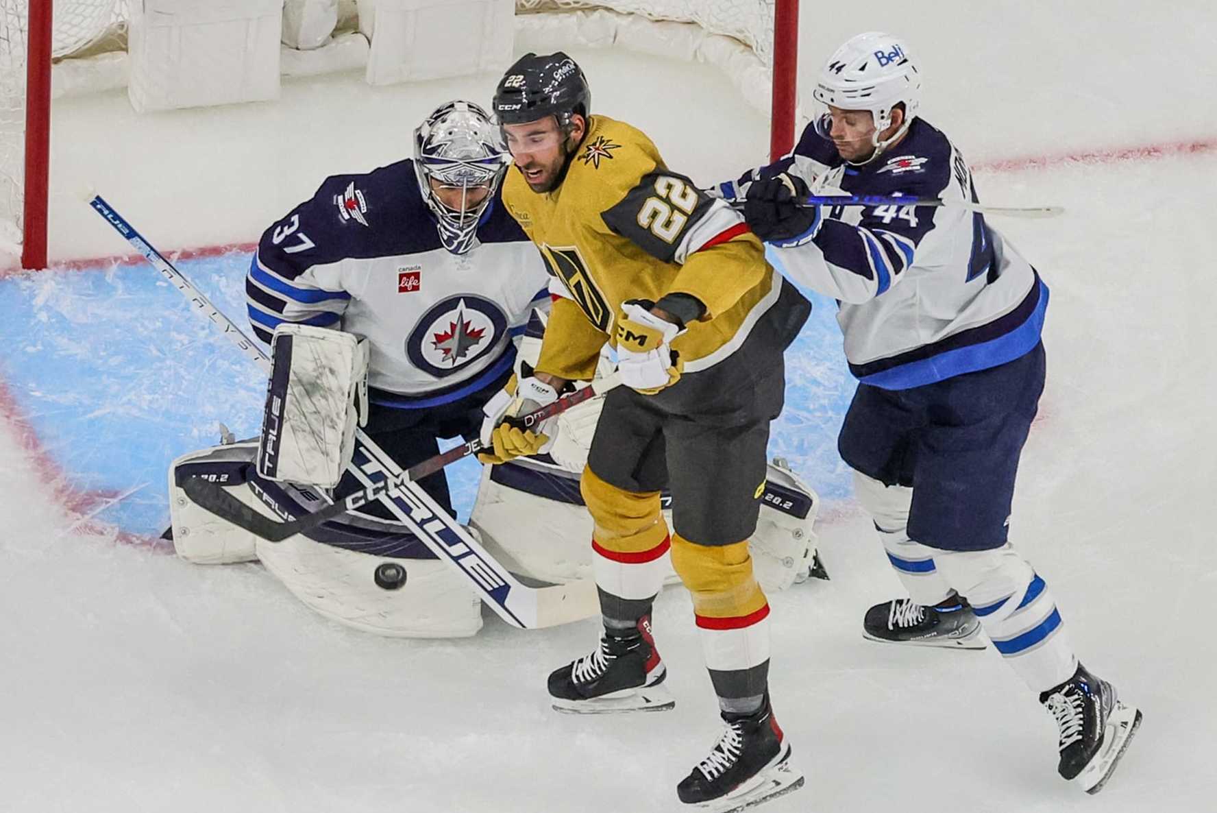 LAS VEGAS, NEVADA - APRIL 18: Michael Amadio #22 of the Vegas Golden Knights tries to redirect a shot past Connor Hellebuyck #37 of the Winnipeg Jets as Josh Morrissey #44 of the Jets defends in the first period of Game One of the First Round of the 2023 Stanley Cup Playoffs at T-Mobile Arena on April 18, 2023 in Las Vegas, Nevada. The Jets defeated the Golden Knights 5-1. (Photo by Ethan Miller/Getty Images)