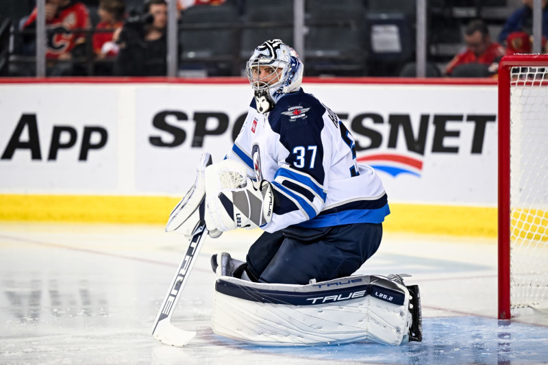 CALGARY, AB - OCTOBER 02: Winnipeg Jets Goalie Connor Hellebuyck (37) stretches during the first period of an NHL preseason game between the Calgary Flames and the Winnipeg Jets on October 2, 2023, at the Scotiabank Saddledome in Calgary, AB. (Photo by Brett Holmes/Icon Sportswire via Getty Images)