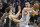 Denver Nuggets center Nikola Jokic (15) throws a pass as he is defended by Sacramento Kings guard Kevin Huerter (9) and forward Trey Lyles during the second half of an NBA basketball game in Sacramento, Calif., Tuesday, Dec. 27, 2022. The Nuggets won 113-106. (AP Photo/José Luis Villegas)