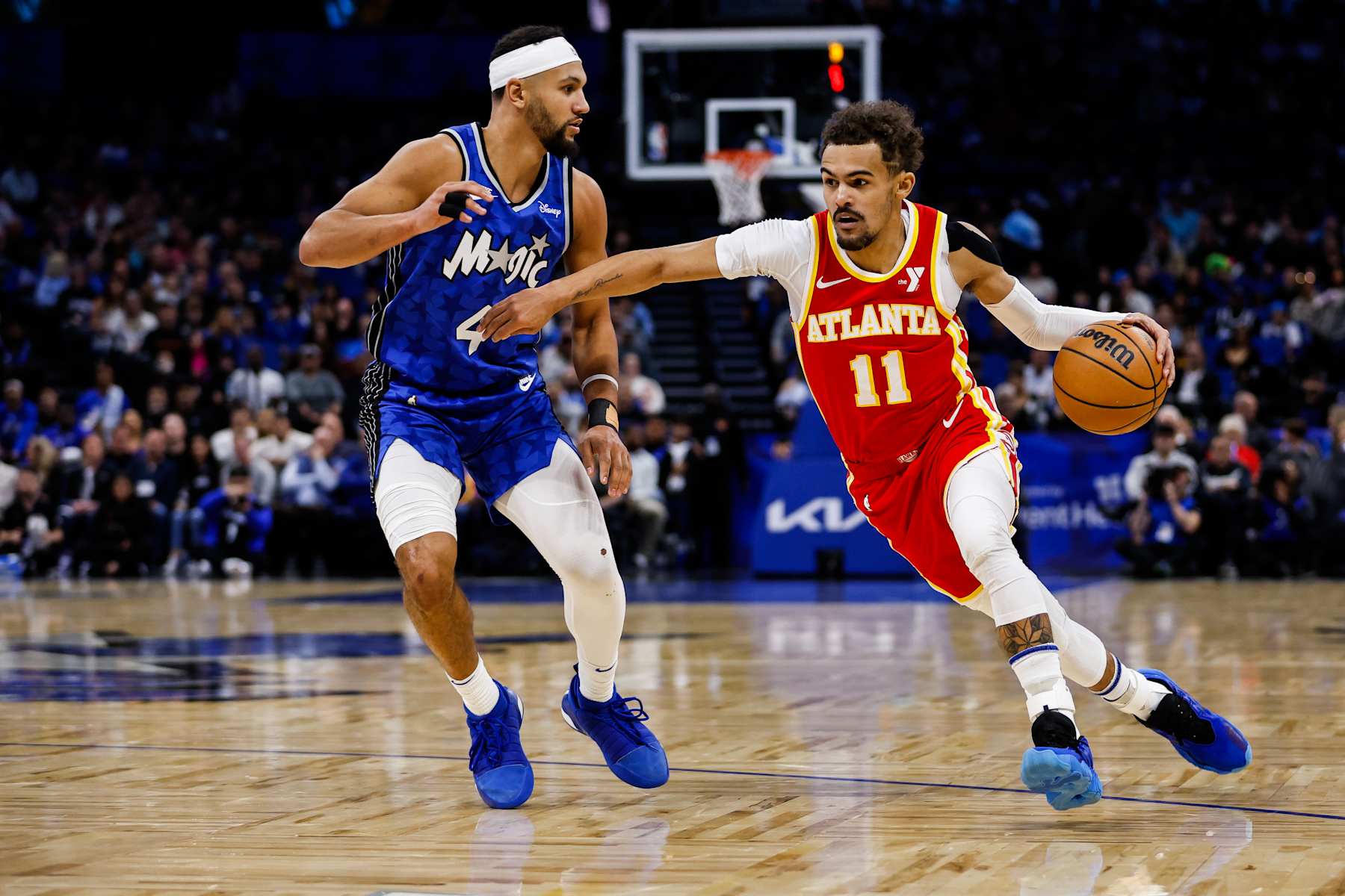 ORLANDO, FLORIDA - JANUARY 07: Trae Young #11 of the Atlanta Hawks dribbles the ball against Jalen Suggs #4 of the Orlando Magic during the first half of a game at the Kia Center on January 07, 2024 in Orlando, Florida. NOTE TO USER: User expressly acknowledges and agrees that, by downloading and or using this photograph, User is consenting to the terms and conditions of the Getty Images License Agreement. (Photo by James Gilbert/Getty Images)