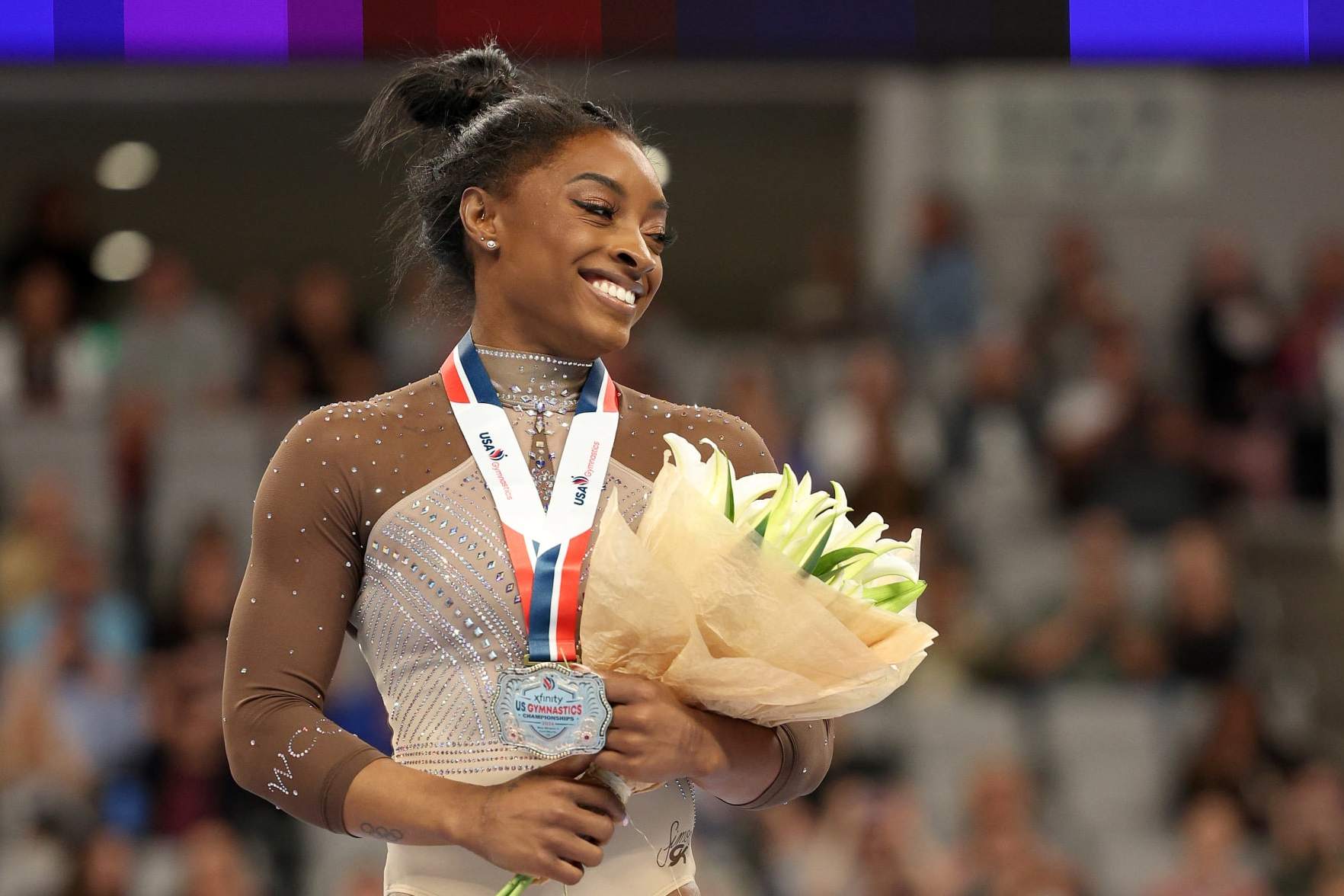 FORT WORTH, TEXAS - JUNE 02: First place all around winner Simone Biles celebrates after the 2024 Xfinity U.S. Gymnastics Championships at Dickies Arena on June 02, 2024 in Fort Worth, Texas. (Photo by Elsa/Getty Images)