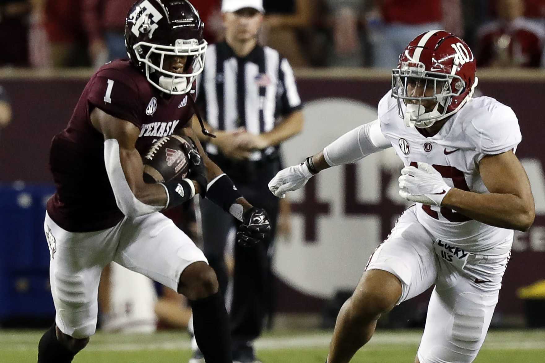 COLLEGE STATION, TEXAS - OCTOBER 09: Demond Demas #1 of the Texas A&M Aggies runs with the ball as Henry To'oTo'o #10 of the Alabama Crimson Tide pursues at Kyle Field on October 09, 2021 in College Station, Texas. (Photo by Bob Levey/Getty Images)