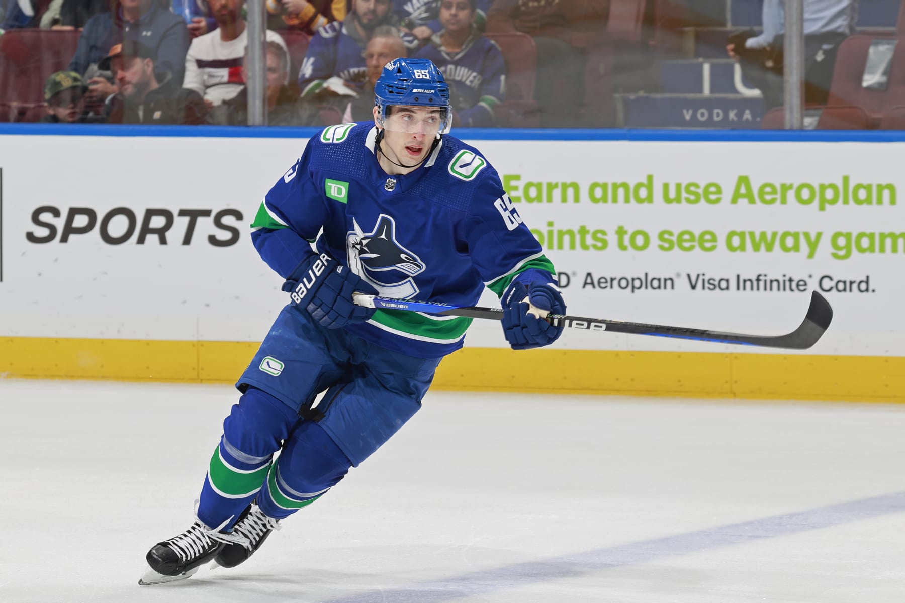 VANCOUVER, CANADA - MARCH 23: Ilya Mikheyev #65 of the Vancouver Canucks skates up the ice during their NHL game against the Calgary Flames at Rogers Arena on March 23, 2024 in Vancouver, British Columbia, Canada.  (Photo by Jeff Vinnick/NHLI via Getty Images)