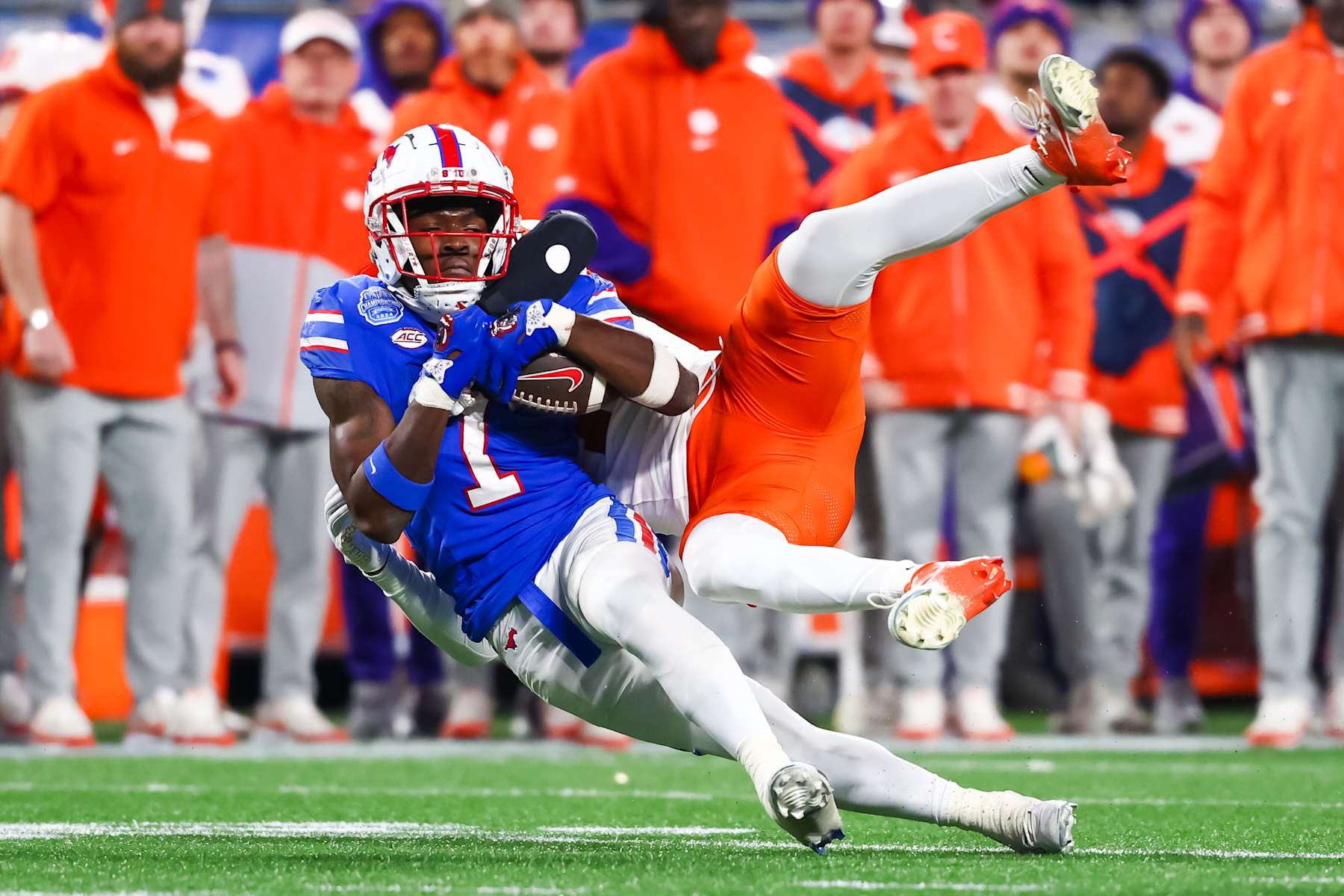 CHARLOTTE, NORTH CAROLINA - DECEMBER 07: Brashard Smith #1 of the Southern Methodist Mustangs is tackled as he runs the ball during the second half of the ACC Championship game against the Clemson Tigers at Bank of America Stadium on December 07, 2024 in Charlotte, North Carolina. (Photo by David Jensen/Getty Images)