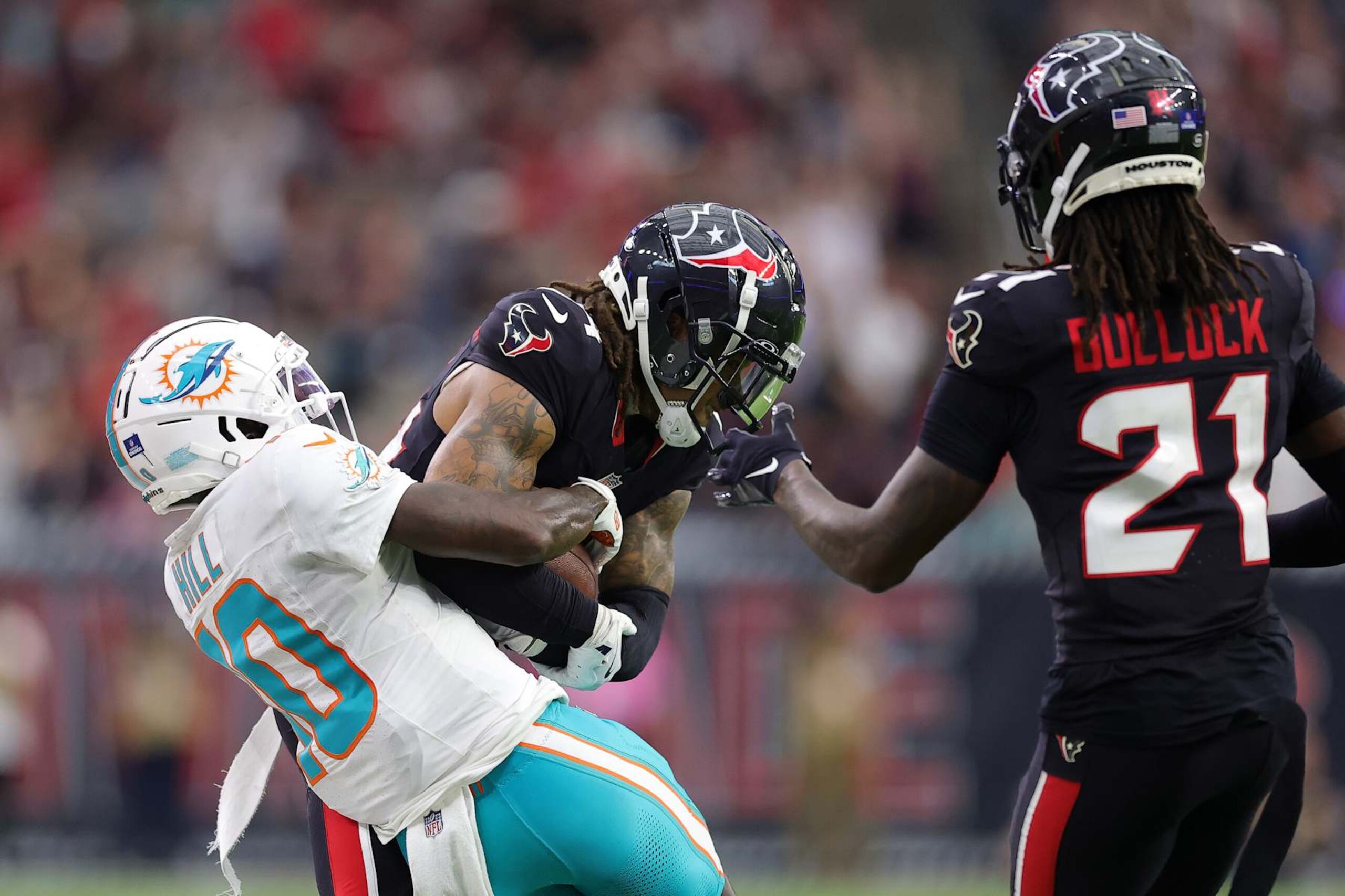 Houston Texans cornerback Derek Stingley Jr. steals and interception from Miami Dolphins wide receiver Tyreek Hill.