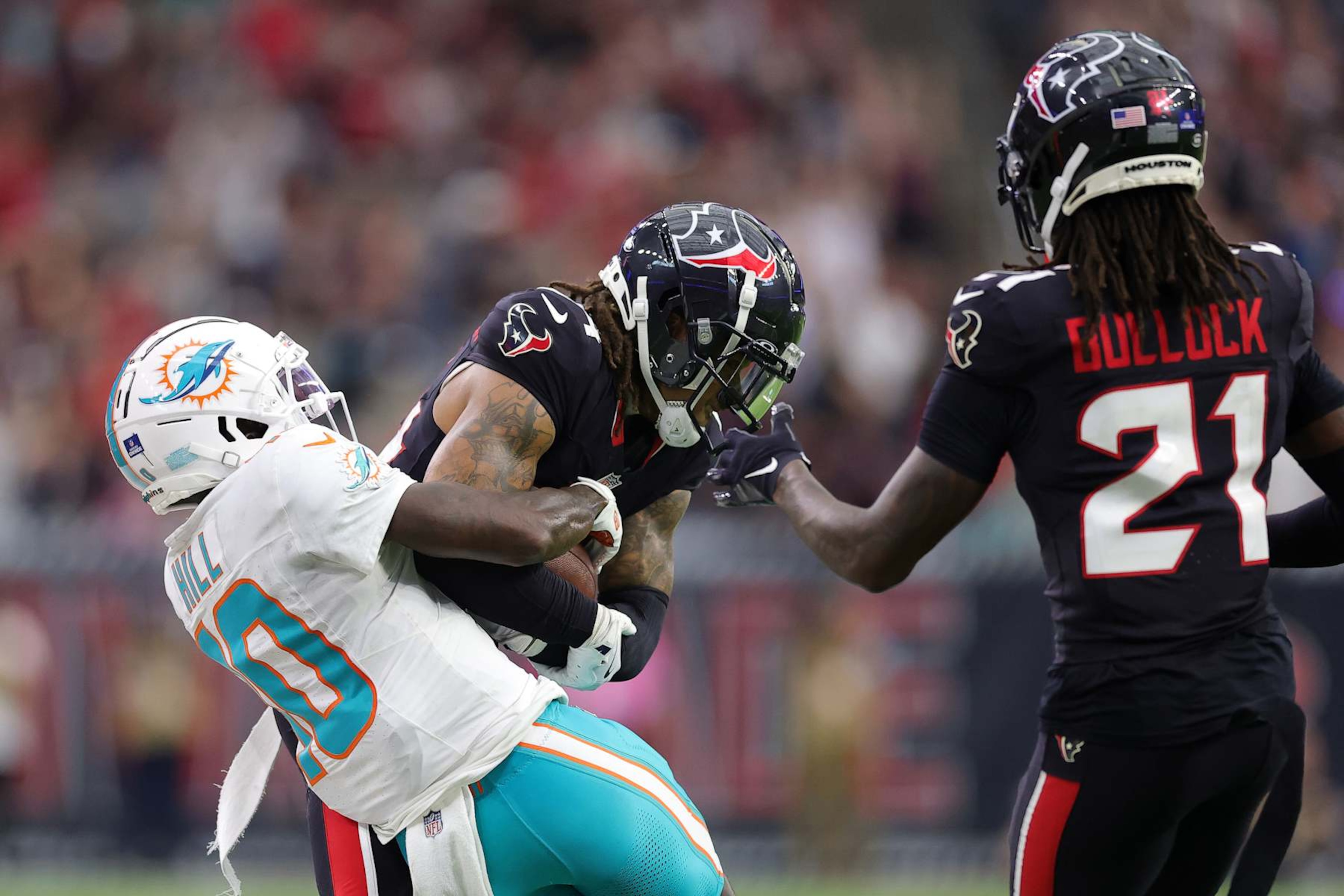 Houston Texans cornerback Derek Stingley Jr. steals and interception from Miami Dolphins wide receiver Tyreek Hill.