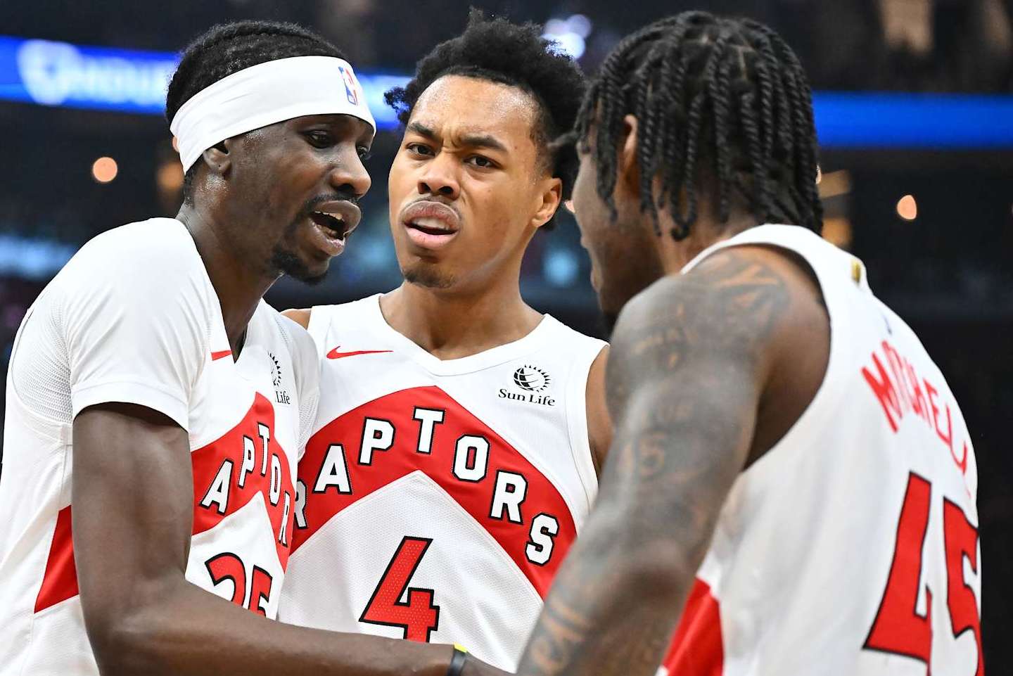 CLEVELAND, OHIO - JANUARY 09: Chris Boucher #25 Scottie Barnes #4 and Davion Mitchell #45 of the Toronto Raptors celebrate during the first quarter against the Cleveland Cavaliers at Rocket Mortgage Fieldhouse on January 09, 2025 in Cleveland, Ohio. NOTE TO USER: User expressly acknowledges and agrees that, by downloading and or using this photograph, User is consenting to the terms and conditions of the Getty Images License Agreement. (Photo by Jason Miller/Getty Images)