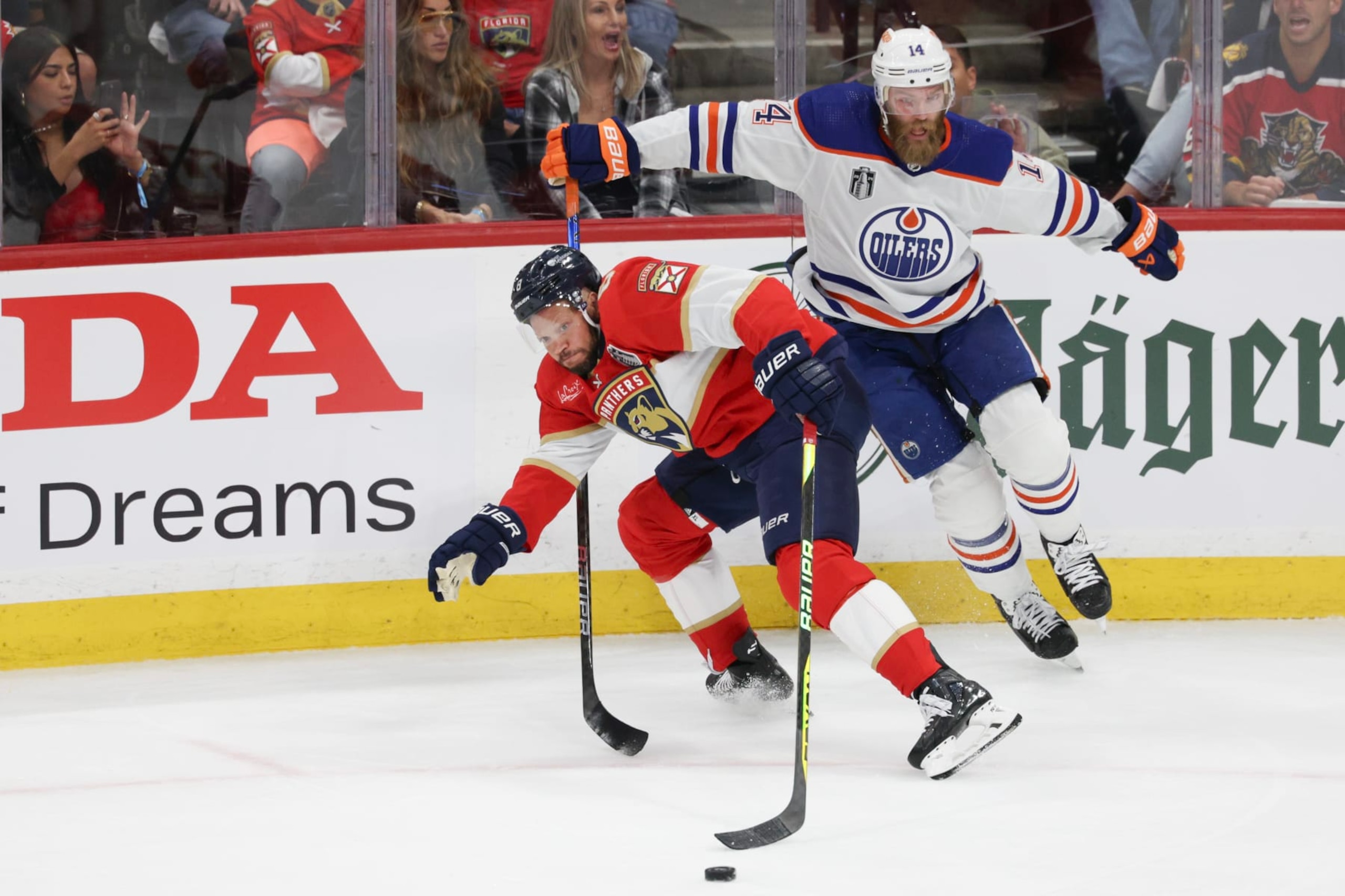 SUNRISE, FLORIDA - JUNE 08: Kyle Okposo #8 of the Florida Panthers collides with Mattias Ekholm #14 of the Edmonton Oilers during the first period in Game One of the 2024 Stanley Cup Final at Amerant Bank Arena on June 08, 2024 in Sunrise, Florida.  (Photo by Elsa/Getty Images)