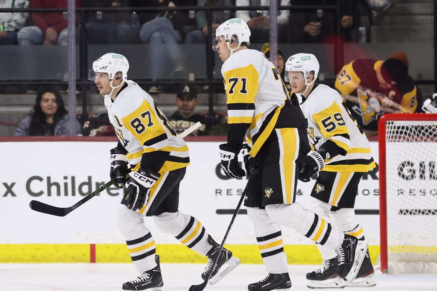 TEMPE, ARIZONA - JANUARY 22: Sidney Crosby #87 of the Pittsburgh Penguins reacts with Evgeni Malkin #71 and Jake Guentzel #59 after scoring a goal against the Arizona Coyotes during the second period of the NHL game at Mullett Arena on January 22, 2024 in Tempe, Arizona. (Photo by Christian Petersen/Getty Images)