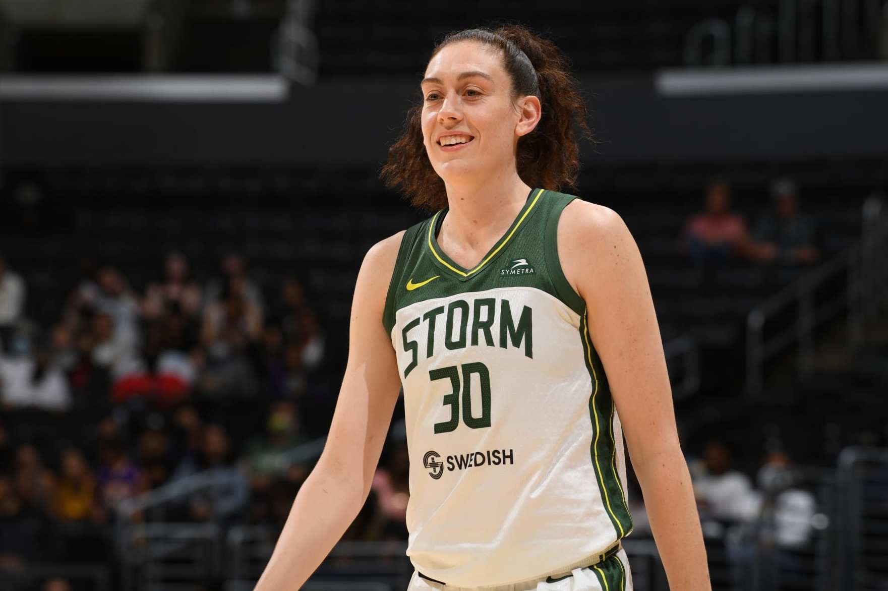 LOS ANGELES, CA - JULY 7: Breanna Stewart #30 of the Seattle Storm looks on and smiles during the game against the Los Angeles Sparks on July 7, 2022 at Crypto.com Arena in Los Angeles, California. NOTE TO USER: User expressly acknowledges and agrees that, by downloading and/or using this Photograph, user is consenting to the terms and conditions of the Getty Images License Agreement. Mandatory Copyright Notice: Copyright 2022 NBAE (Photo by Juan Ocampo/NBAE via Getty Images)