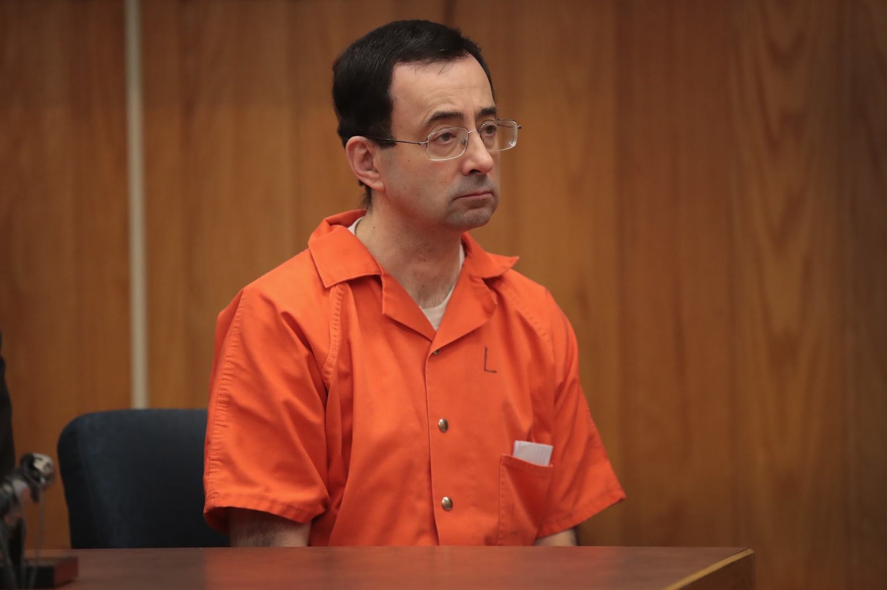 CHARLOTTE, MI - FEBRUARY 05:  Larry Nassar sits in court listening to statements before being sentenced by Judge Janice Cunningham for three counts of criminal sexual assault in Eaton County Circuit Court on February 5, 2018 in Charlotte, Michigan. Nassar has been accused of sexually assaulting more than 150 girls and young women while he was a physician for USA Gymnastics and Michigan State University. Cunningham sentenced Nassar to 40 to 125 years in prison. He is currently serving a 60-year sentence in federal prison for possession of child pornography. Last month a judge in Ingham County, Michigan sentenced Nassar to an 40 to 175 years in prison after he plead guilty to sexually assaulting seven girls.  (Photo by Scott Olson/Getty Images)