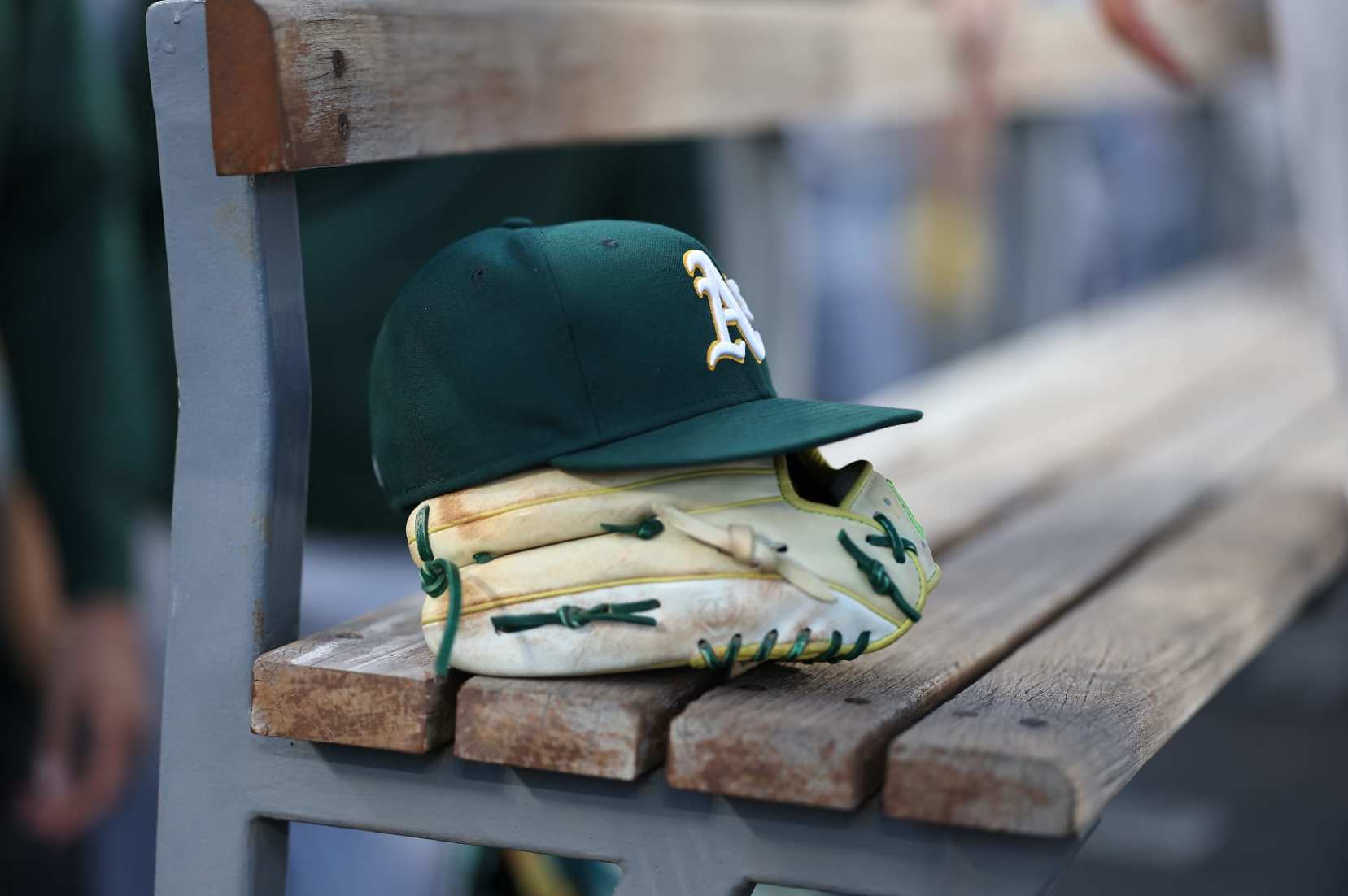 LOS ANGELES, CALIFORNIA - AUGUST 02: A general view of an Oakland Athletics glove and hat in the dugout prior to a game against the Los Angeles Dodgers at Dodger Stadium on August 02, 2023 in Los Angeles, California. (Photo by Michael Owens/Getty Images)