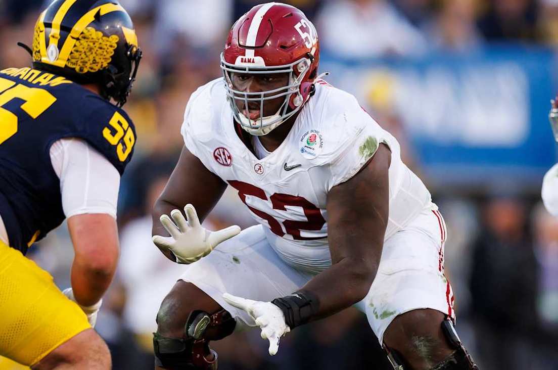 PASADENA, CALIFORNIA - JANUARY 01: Offensive lineman Tyler Booker #52 of the Alabama Crimson Tide blocks during the CFP Semifinal Rose Bowl Game against the Michigan Wolverines at Rose Bowl Stadium on January 1, 2024 in Pasadena, California. (Photo by Ryan Kang/Getty Images)