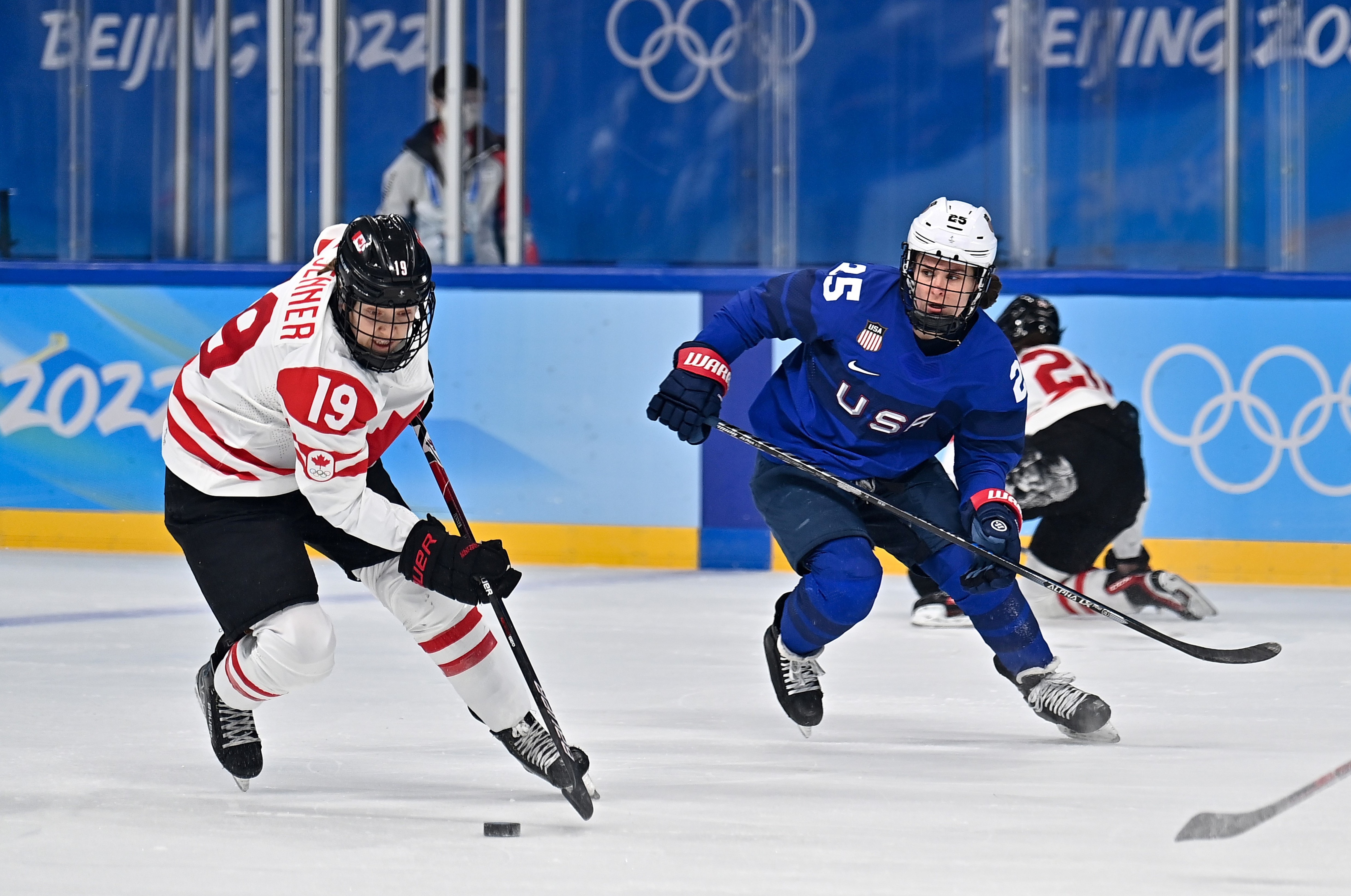 Alex Carpenter R of the United States vies with Brianne Jenner of Canada during the ice hockey women's preliminary round group A match between Canada and the United States at Wukesong Sports Centre in Beijing, capital of China, Feb. 8, 2022. (Photo by Song Yanhua/Xinhua via Getty Images)