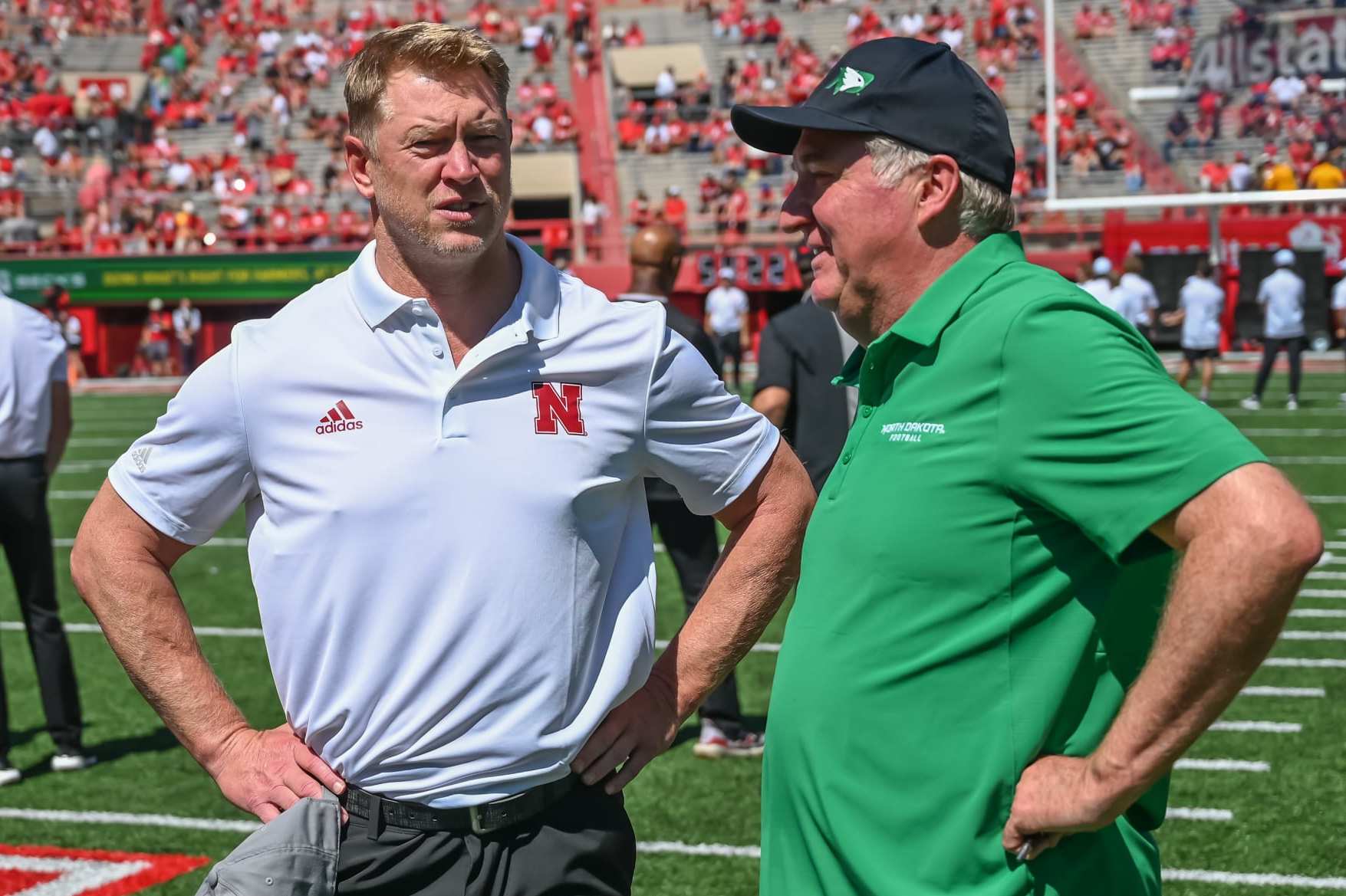 LINCOLN, NE - SEPTEMBER 3: Head coach Scott Frost of the Nebraska Cornhuskers and head coach Bubba Schweigert of the North Dakota Fighting Hawks meet on the field before the game at Memorial Stadium on September 3, 2022 in Lincoln, Nebraska. (Photo by Steven Branscombe/Getty Images)