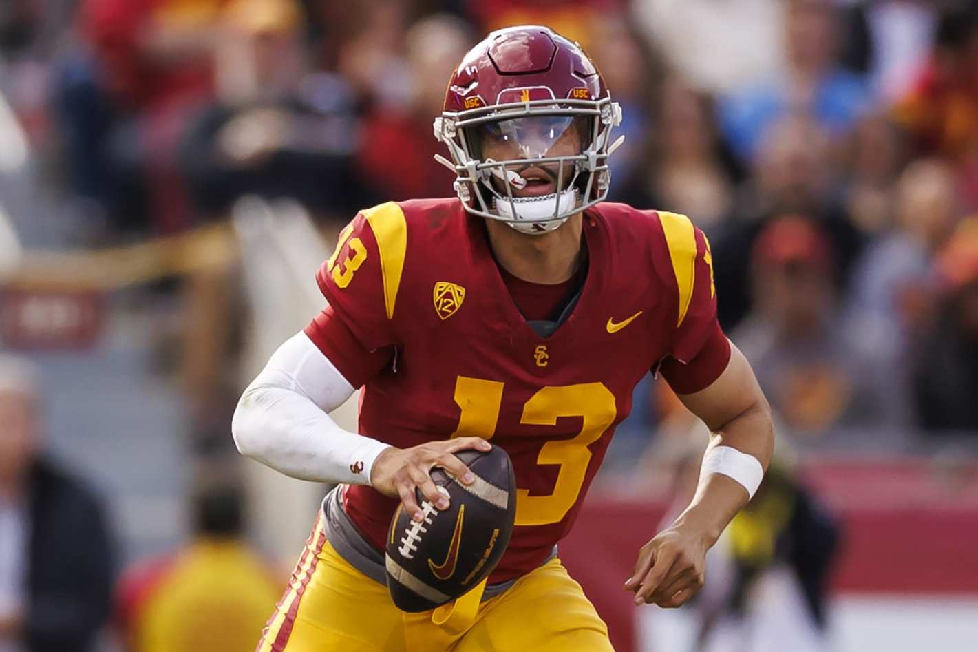LOS ANGELES, CALIFORNIA - NOVEMBER 18: Caleb Williams #13 of the USC Trojans looks to throw a pass as he scrambles during the first half of a game against the UCLA Bruins at United Airlines Field at the Los Angeles Memorial Coliseum on November 18, 2023 in Los Angeles, California. (Photo by Ryan Kang/Getty Images)