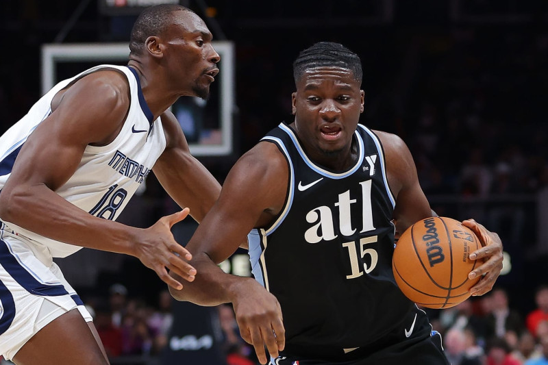 ATLANTA, GEORGIA - DECEMBER 23: Clint Capela #15 of the Atlanta Hawks pushes the ball against Bismack Biyombo #18 of the Memphis Grizzlies during the first quarter at State Farm Arena on December 23, 2023 in Atlanta, Georgia. NOTE TO USER: User expressly acknowledges and agrees that, by downloading and/or using this photograph, user is consenting to the terms and conditions of the Getty Images License Agreement. (Photo by Kevin C. Cox/Getty Images)