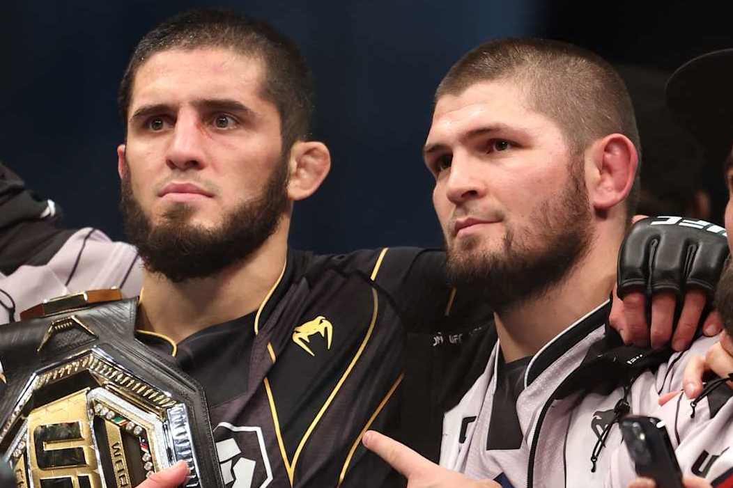 Islam Makhachev (2nd-L) poses for a picture with his coach Khabib Nurmagomedov (2nd-R) and Russian social media star Hasbulla Magomedov (R) after defeating Charles Oliveira in the lightweight championship at the Ultimate Fighting Championship (UFC) event at the Etihad Arena in Abu Dhabi on October 22, 2022. (Photo by Giuseppe CACACE / AFP) (Photo by GIUSEPPE CACACE/AFP via Getty Images)