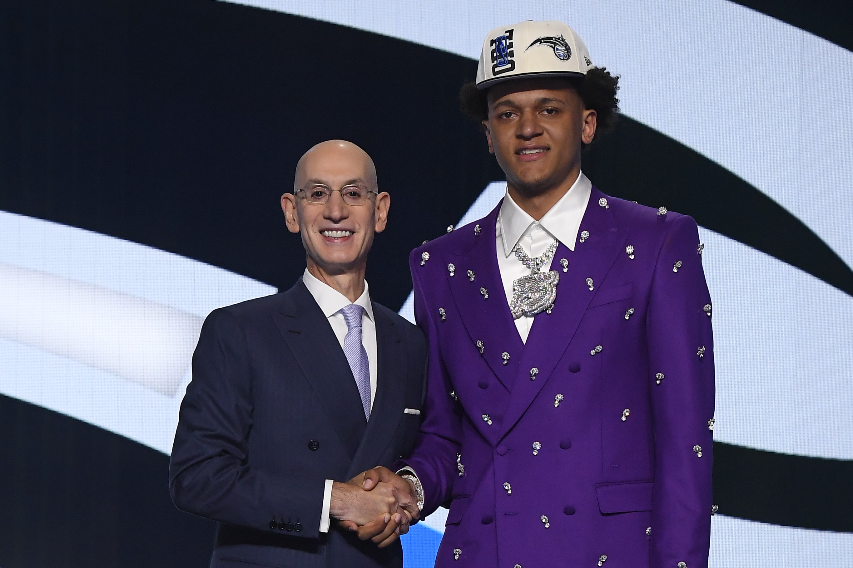 BROOKLYN, NY - JUNE 23: Paolo Banchero shakes hands with NBA Commissioner Adam Silver after being selected number one overall by the Orlando Magic during the 2022 NBA Draft on June 23, 2022 at Barclays Center in Brooklyn, New York. NOTE TO USER: User expressly acknowledges and agrees that, by downloading and or using this photograph, User is consenting to the terms and conditions of the Getty Images License Agreement. Mandatory Copyright Notice: Copyright 2022 NBAE (Photo by Brian Babineau/NBAE via Getty Images) BROOKLYN, NY - JUNE 23: Paolo Banchero shakes hands with NBA Commissioner Adam Silver after being selected number one overall by the Orlando Magic during the 2022 NBA Draft on June 23, 2022 at Barclays Center in Brooklyn, New York. NOTE TO USER: User expressly acknowledges and agrees that, by downloading and or using this photograph, User is consenting to the terms and conditions of the Getty Images License Agreement. Mandatory Copyright Notice: Copyright 2022 NBAE (Photo by Brian Babineau/NBAE via Getty Images)