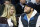 FILE - In this Nov. 17, 2015, file photo, Detroit Lions quarterback Matthew Stafford, right, smiles while watching the Detroit Pistons play the Cleveland Cavaliers with his wife Kelly, left, during the first half of an NBA basketball game, in Auburn Hills, Mich. Kelly Stafford plans to have surgery to remove a brain tumor. Stafford shared the details Wednesday, April 3, 2019, on her Instagram account. She says an MRI showed the tumor on cranial nerves after she had vertigo spells within the last year. (AP Photo/Duane Burleson, File)