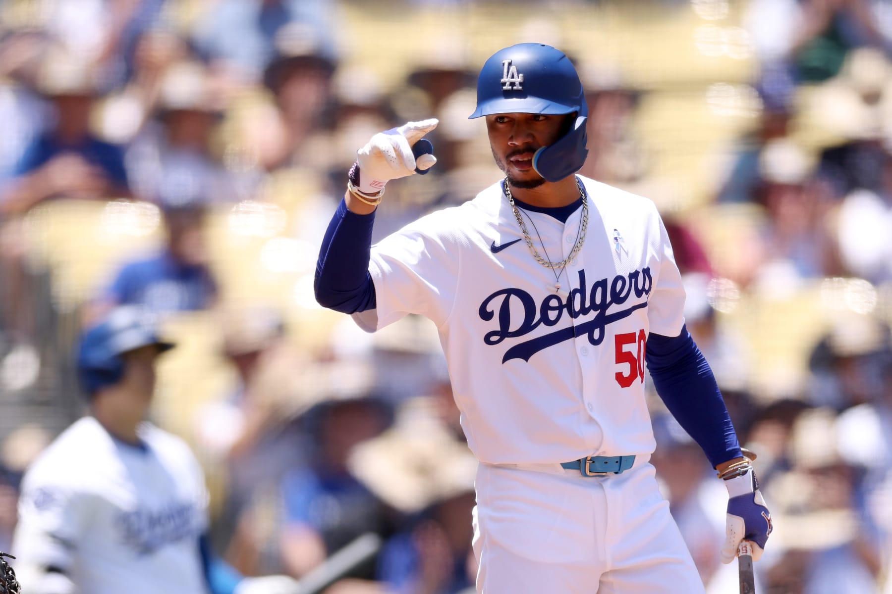 LOS ANGELES, CALIFORNIA - JUNE 16: Mookie Betts #50 of the Los Angeles Dodgers signals to the Kansas City Royals bench during the first inning at Dodger Stadium on June 16, 2024 in Los Angeles, California. (Photo by Katelyn Mulcahy/Getty Images)