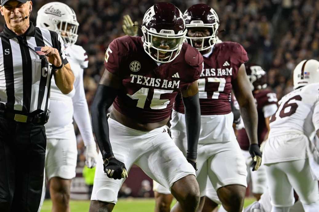 COLLEGE STATION, TX - NOVEMBER 11: The referee grimaces in pain after Texas A&M Aggies linebacker Edgerrin Cooper (45) banged into his hand in celebrating a key stop during the football game between the Mississippi State Bulldogs and Texas A&M Aggies at Kyle Field on November 11, 2023 in College Station, Texas. (Photo by Ken Murray/Icon Sportswire via Getty Images)