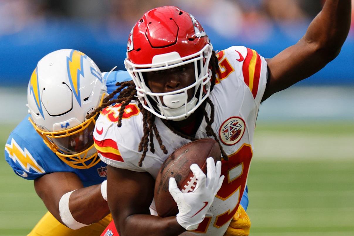 INGLEWOOD, CALIFORNIA - SEPTEMBER 29: Kareem Hunt #29 of the Kansas City Chiefs runs the ball and is tackled by Daiyan Henley #0 of the Los Angeles Chargers during the third quarter at SoFi Stadium on September 29, 2024 in Inglewood, California. (Photo by Kevork Djansezian/Getty Images)