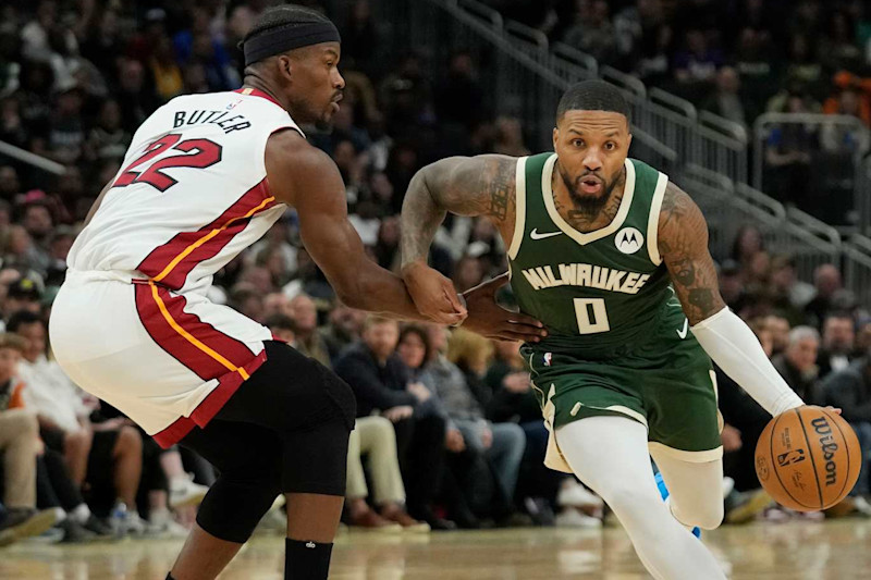 MILWAUKEE, WISCONSIN - OCTOBER 30: Damian Lillard #0 of the Milwaukee Bucks dribbles the ball against Jimmy Butler #22 of the Miami Heat during the first half at Fiserv Forum on October 30, 2023 in Milwaukee, Wisconsin. NOTE TO USER: User expressly acknowledges and agrees that, by downloading and or using this photograph, User is consenting to the terms and conditions of the Getty Images License Agreement. (Photo by Patrick McDermott/Getty Images)