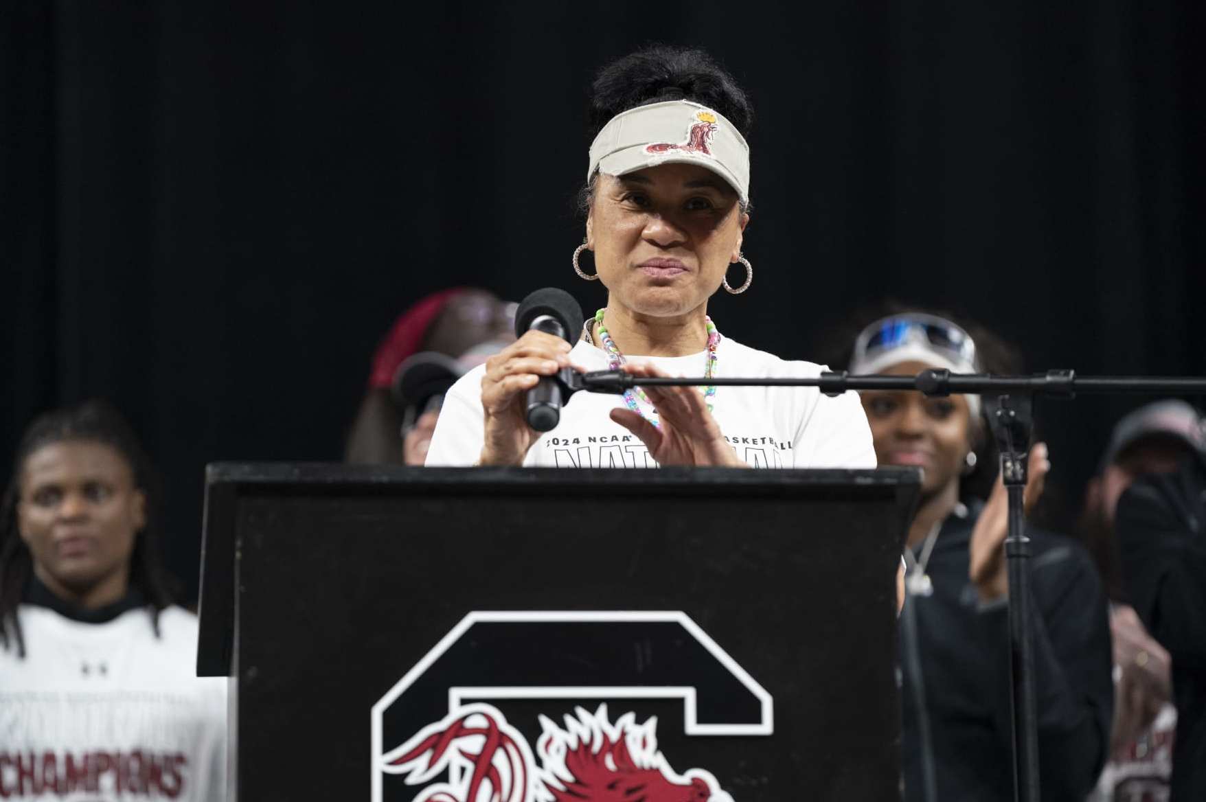 COLUMBIA, SOUTH CAROLINA - APRIL 8:  South Carolina coach Dawn Staley adjusts the microphone during an NCAA Women's Basketball Championship celebration at Colonial Life Arena on April 8, 2024 in Columbia, South Carolina. University classes that were scheduled during the event were canceled. The South Carolina Gamecocks defeated the Iowa Hawkeyes 87-75 to cap a perfect season. 
 (Photo by Sean Rayford/Getty Images)
