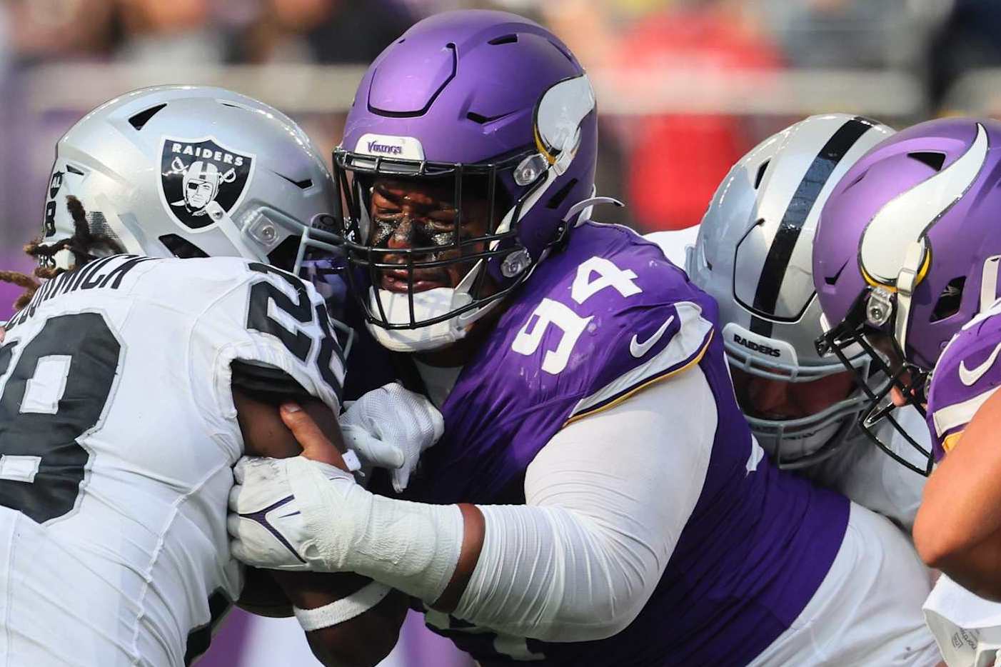 MINNEAPOLIS, MINNESOTA - AUGUST 10: Taki Taimani #94 of the Minnesota Vikings tackles Sincere McCormick #28 of the Las Vegas Raiders in the fourth quarter of the pre-season game at U.S. Bank Stadium on August 10, 2024 in Minneapolis, Minnesota. The Minnesota Vikings defeated the Las Vegas Raiders 24-23.(Photo by Adam Bettcher/Getty Images)