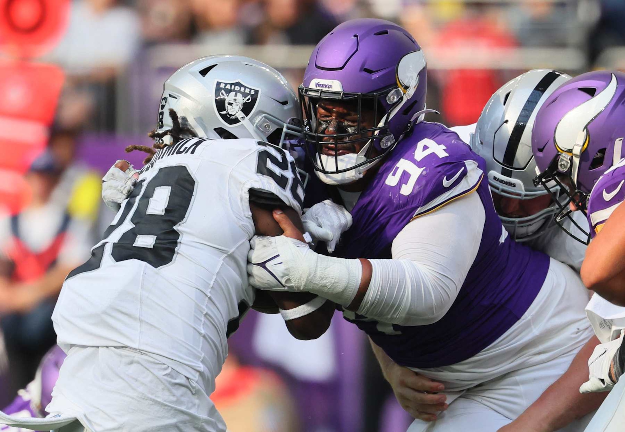 MINNEAPOLIS, MINNESOTA - AUGUST 10: Taki Taimani #94 of the Minnesota Vikings tackles Sincere McCormick #28 of the Las Vegas Raiders in the fourth quarter  of the pre-season game at U.S. Bank Stadium on August 10, 2024 in Minneapolis, Minnesota. The Minnesota Vikings defeated the Las Vegas Raiders 24-23.(Photo by Adam Bettcher/Getty Images)