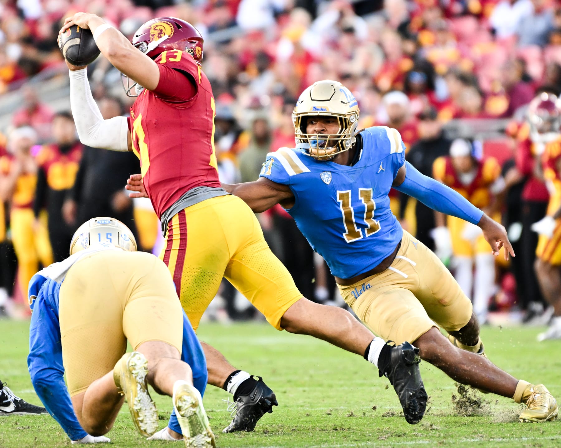 LOS ANGELES, CA - NOVEMBER 18: UCLA Bruins defensive lineman Gabriel Murphy (11) and defensive lineman Laiatu Latu (15) pressure USC Trojans quarterback Caleb Williams (13) in the pocket during the second half at Los Angeles Memorial Coliseum on Saturday, Nov. 18, 2023 in Los Angeles, CA. (Wally Skalij / Los Angeles Times via Getty Images)