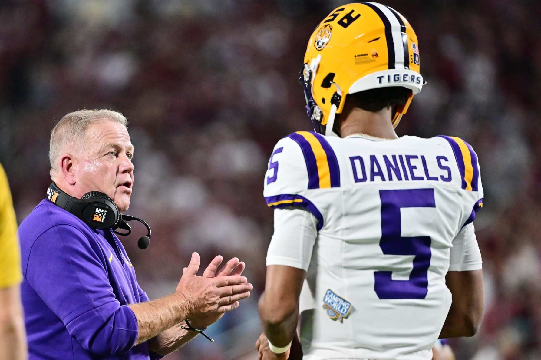 ORLANDO, FLORIDA - SEPTEMBER 03: Head coach Brian Kelly of the LSU Tigers talks with Jayden Daniels #5 during a timeout in the first quarter against the Florida State Seminoles at Camping World Stadium on September 03, 2023 in Orlando, Florida. (Photo by Julio Aguilar/Getty Images)