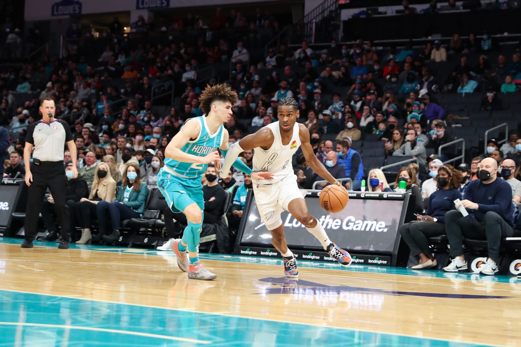 CHARLOTTE, NC - JANUARY 21: Shai Gilgeous-Alexander #2 of the Oklahoma City Thunder handles the ball as LaMelo Ball #2 of the Charlotte Hornets plays defense during the game on January 21, 2022 at Spectrum Center in Charlotte, North Carolina. NOTE TO USER: User expressly acknowledges and agrees that, by downloading and or using this photograph, User is consenting to the terms and conditions of the Getty Images License Agreement. Mandatory Copyright Notice: Copyright 2022 NBAE (Photo by Brock Williams-Smith/NBAE via Getty Images)