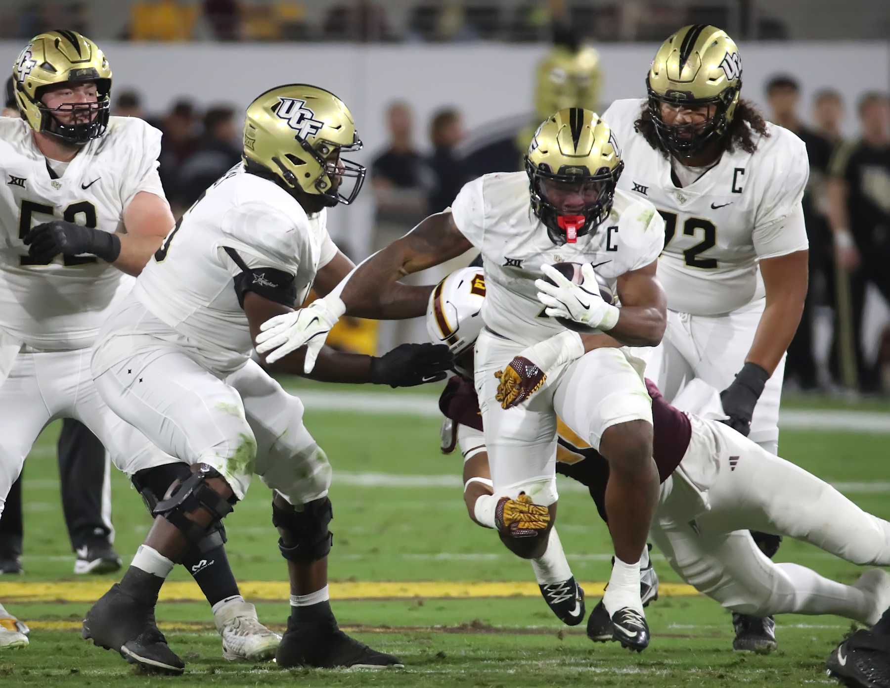 TEMPE, ARIZONA - NOVEMBER 9: Runningback RJ Harvey #7 of the UCF Knights rushes for a first down during the first half of a game between the University of Central Florida Knights and the Arizona State Sun Devils at Sun Devil Stadium on November 9, 2024 in Tempe, Arizona. (Photo by Bruce Yeung/Getty Images)