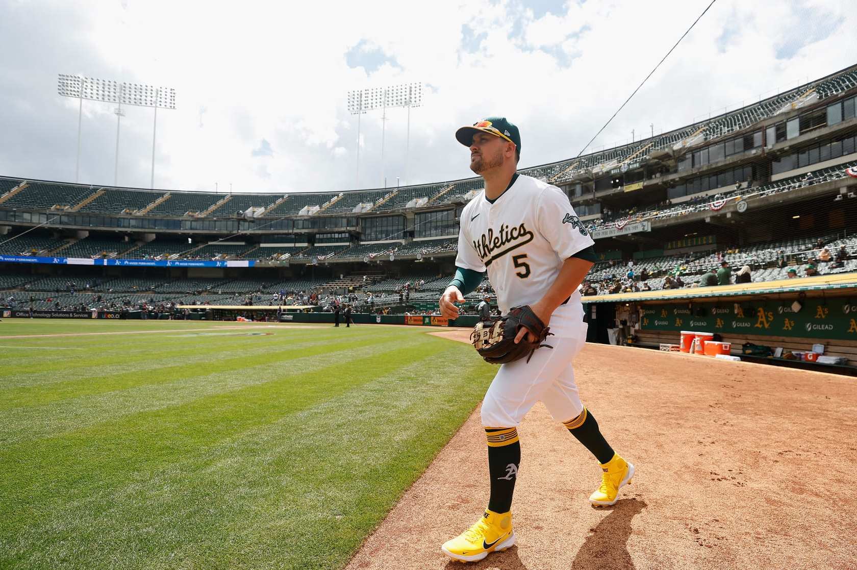 OAKLAND, CALIFORNIA - MARCH 30: J.D. Davis #5 of the Oakland Athletics walks to the field before the game against the Cleveland Guardians at Oakland Coliseum on March 30, 2024 in Oakland, California. (Photo by Lachlan Cunningham/Getty Images)