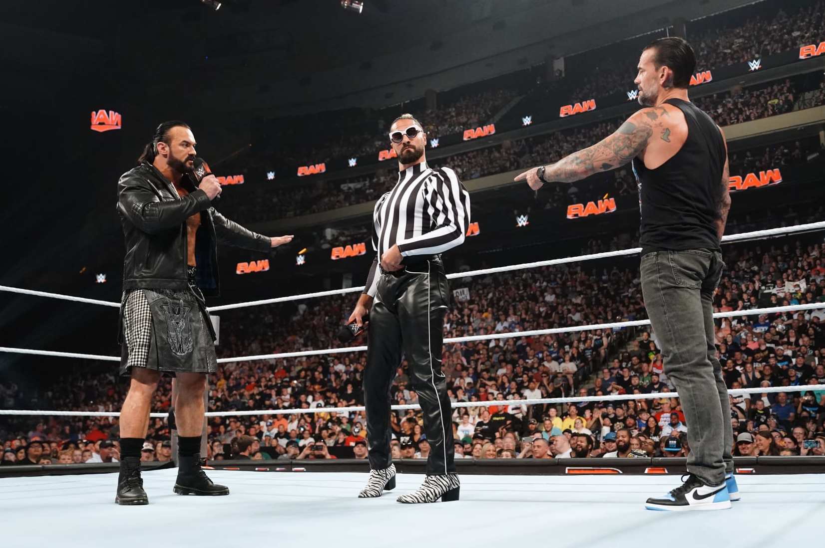 ST PAUL, MINNESOTA - JULY 29: (L-R) Drew Mcintyre, Seth Rollins and CM Punk confront each other in the ring during WWE's Monday Night RAW at Xcel Energy Center on July 29, 2024 in St Paul, Minnesota. (Photo by WWE/Getty Images)