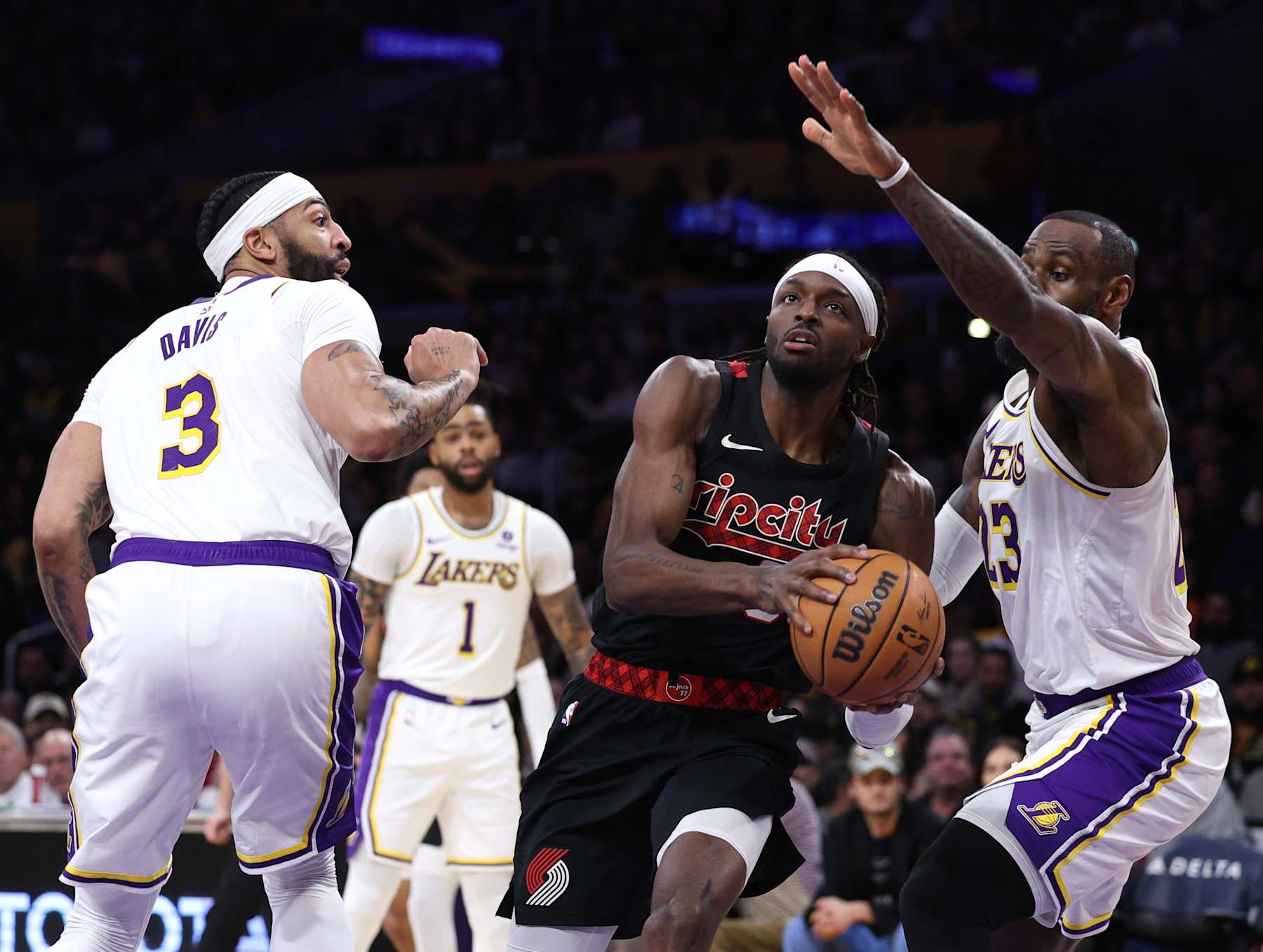 LOS ANGELES, CALIFORNIA - JANUARY 21: Jerami Grant #9 of the Portland Trail Blazers drives to the basket between LeBron James #23 and Anthony Davis #3 of the Los Angeles Lakers during the first half at Crypto.com Arena on January 21, 2024 in Los Angeles, California. User is consenting to the terms and conditions of the Getty Images License Agreement. (Photo by Harry How/Getty Images)