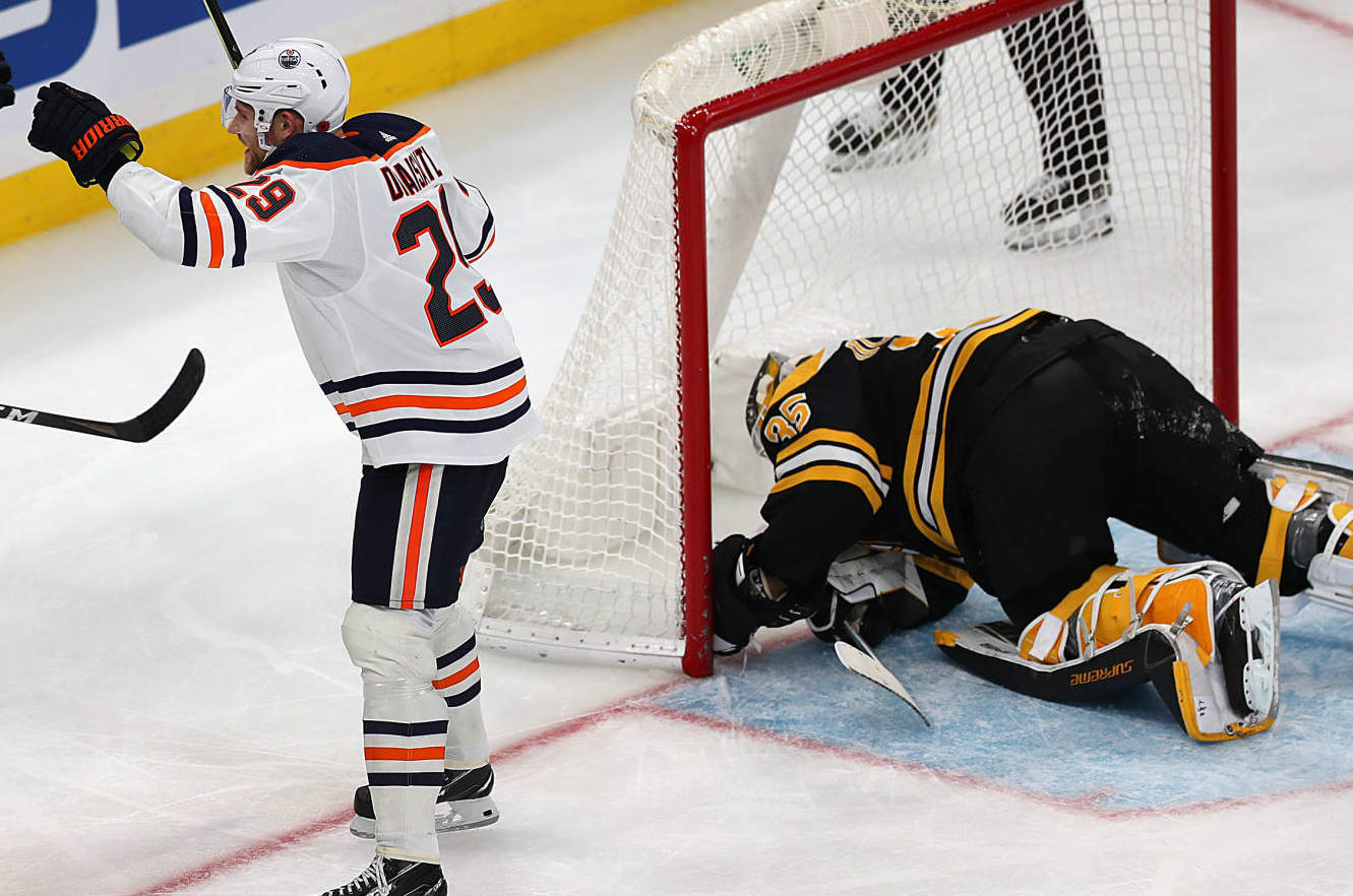 Boston - November 11: Boston Bruins goaltender Linus Ullmark (35) is down in the nest after Edmonton Oilers center Leon Draisaitl (29) scored a 3rd period goal to put the Oilers up 4-3. He is congratulated by Edmonton Oilers defenseman Cody Ceci (5). The Boston Bruins hosted the Edmonton Oilers in a regular season NHL hockey game at TD garden in Boston on November 11, 2021. (Photo by John Tlumacki/The Boston Globe via Getty Images)