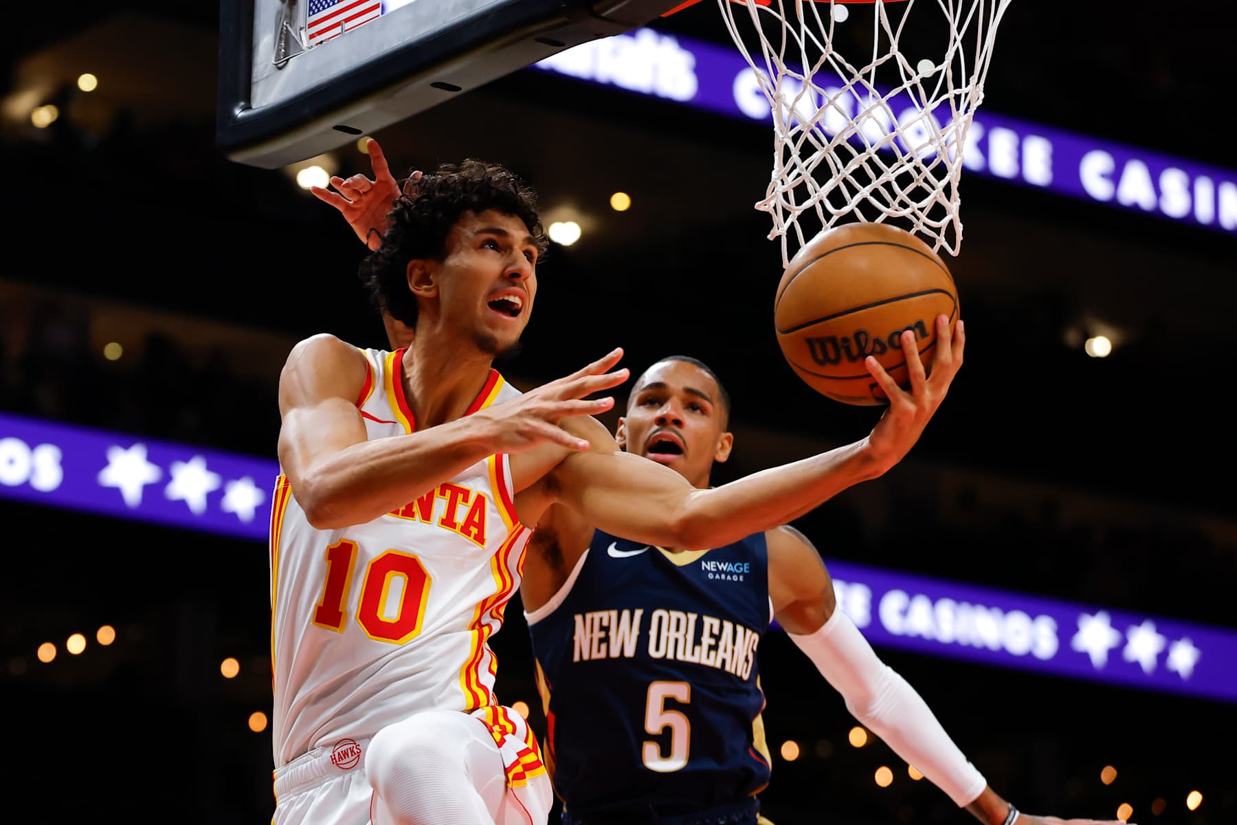 ATLANTA, GEORGIA - DECEMBER 2: Zaccharie Risacher #10 of the Atlanta Hawks goes up for a shot as Dejounte Murray #5 of the New Orleans Pelicans defends during the first quarter at State Farm Arena on December 2, 2024 in Atlanta, Georgia. NOTE TO USER: User expressly acknowledges and agrees that, by downloading and or using this photograph, User is consenting to the terms and conditions of the Getty Images License Agreement. (Photo by Todd Kirkland/Getty Images)