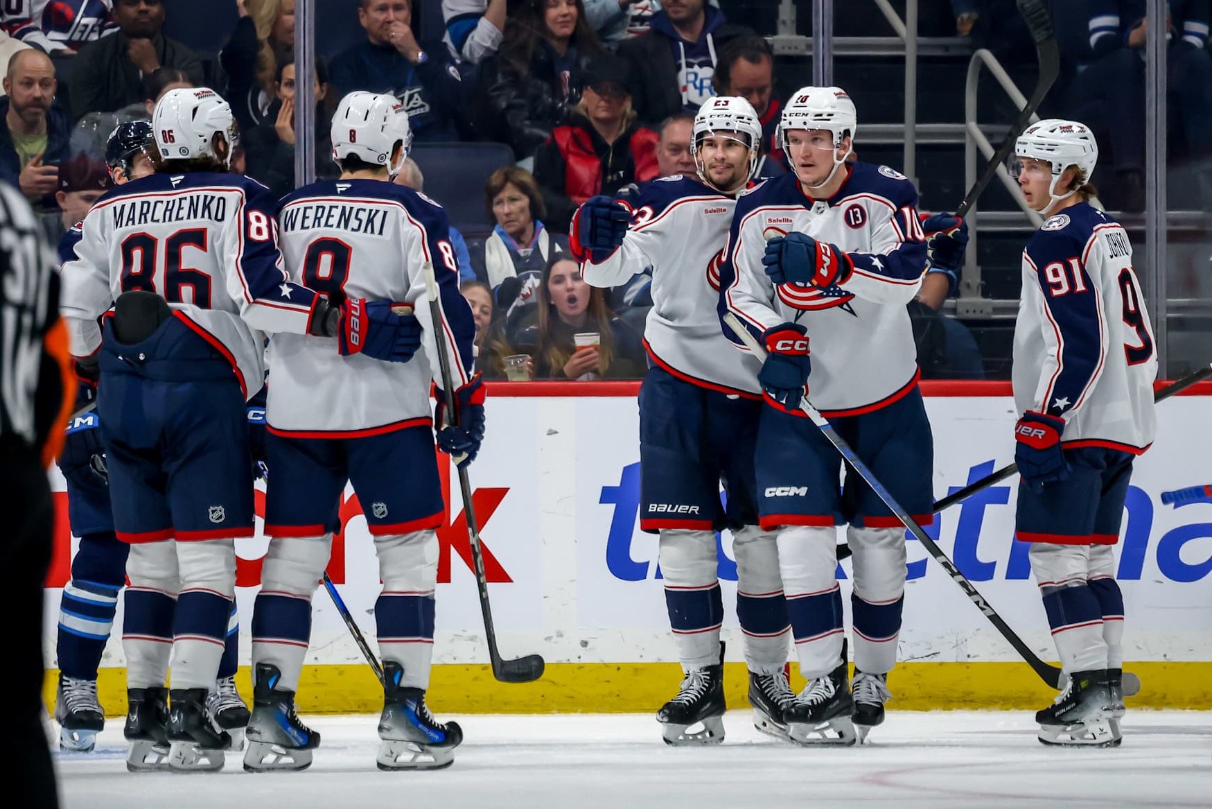 WINNIPEG, CANADA - DECEMBER 8: Kirill Marchenko #86, Zach Werenski #8, Sean Monahan #23, Dmitri Voronkov #10 and Kent Johnson #91 of the Columbus Blue Jackets celebrate a second period goal against the Winnipeg Jets at the Canada Life Centre on December 8, 2024 in Winnipeg, Manitoba, Canada. (Photo by Jonathan Kozub/NHLI via Getty Images)