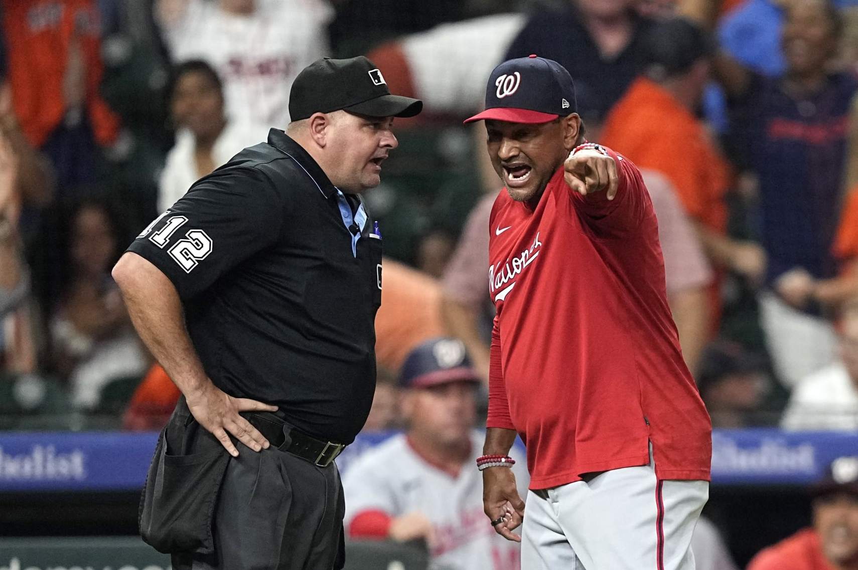 Washington Nationals manager Dave Martinez, right, argues with home plate umpire Jeremy Riggs after the final play during the ninth inning of a baseball game against the Houston Astros Wednesday, June 14, 2023, in Houston. The Astros won 5-4. (AP Photo/David J. Phillip)