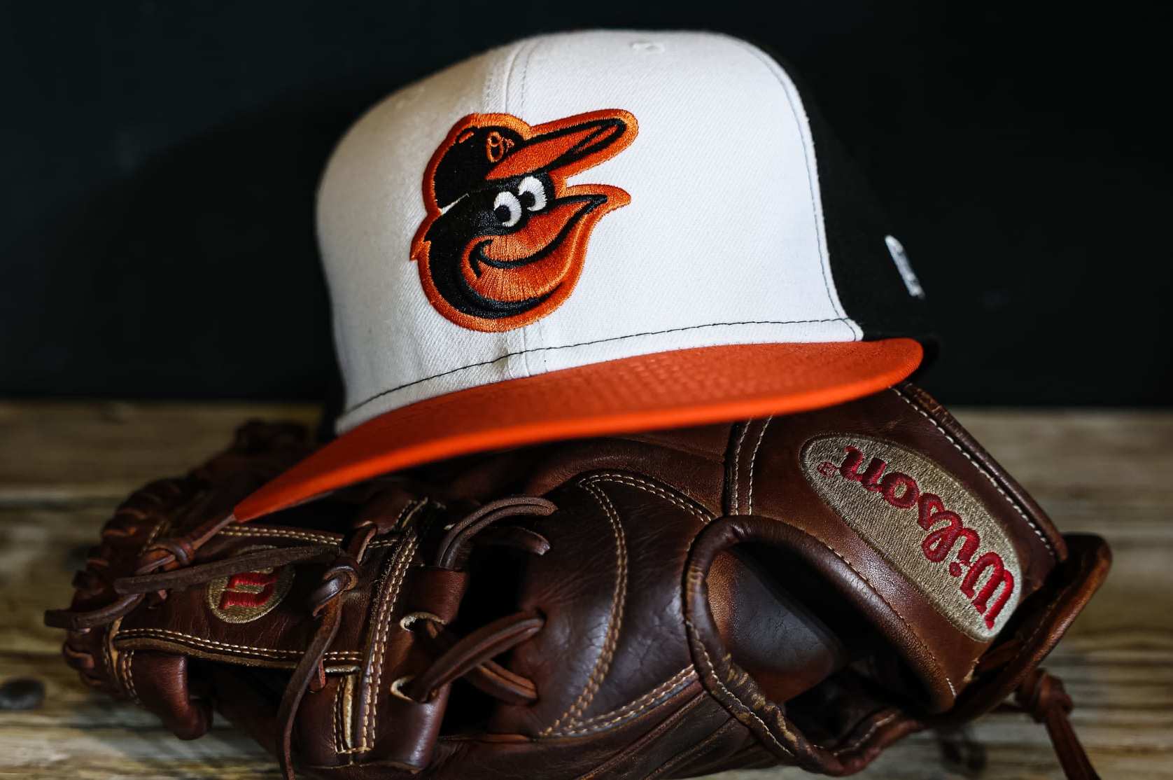 BALTIMORE, MD - APRIL 22: A general view of a Baltimore Orioles hat and glove in the dugout after the game against the Detroit Tigers at Oriole Park at Camden Yards on April 22, 2023 in Baltimore, Maryland. (Photo by Scott Taetsch/Getty Images)