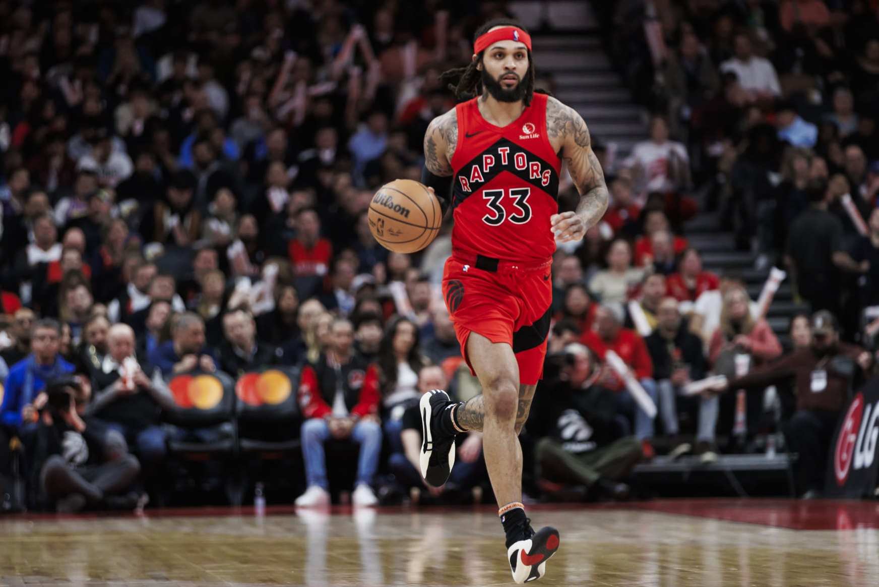 TORONTO, CANADA - FEBRUARY 28: Gary Trent Jr. #33 of the Toronto Raptors dribbles against the Dallas Mavericks second half of their NBA game at Scotiabank Arena on February 28, 2024 in Toronto, Canada. NOTE TO USER: User expressly acknowledges and agrees that, by downloading and or using this photograph, User is consenting to the terms and conditions of the Getty Images License Agreement. (Photo by Cole Burston/Getty Images)