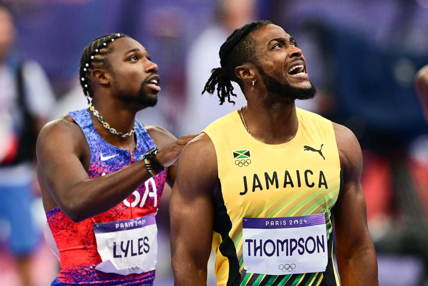 SAINT-DENIS, FRANCE - AUGUST 04: Noah Lyles (L) of US and Kishane Thompson (R) of Jamaika wait for the results of the competition during the men's 100m final of the athletics event at the Paris 2024 Olympic Games at Stade de France in Saint-Denis, north of Paris, on August 4, 2024. (Photo by Mehmet Murat Onel/Anadolu via Getty Images)