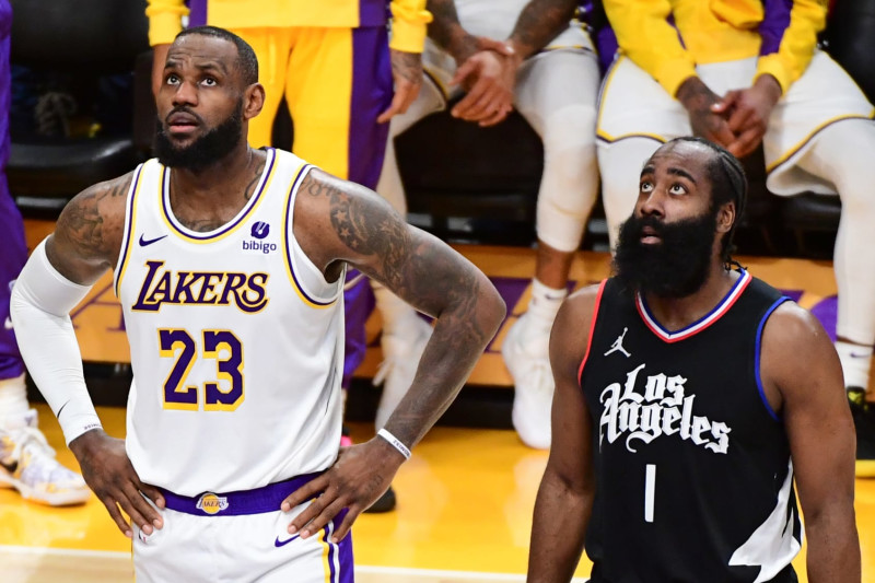 LOS ANGELES, CA - JANUARY 7: LeBron James #23 of the Los Angeles Lakers & James Harden #1 of the LA Clippers look on during the game on January 7, 2024 at Crypto.Com Arena in Los Angeles, California. NOTE TO USER: User expressly acknowledges and agrees that, by downloading and/or using this Photograph, user is consenting to the terms and conditions of the Getty Images License Agreement. Mandatory Copyright Notice: Copyright 2024 NBAE (Photo by Adam Pantozzi/NBAE via Getty Images)