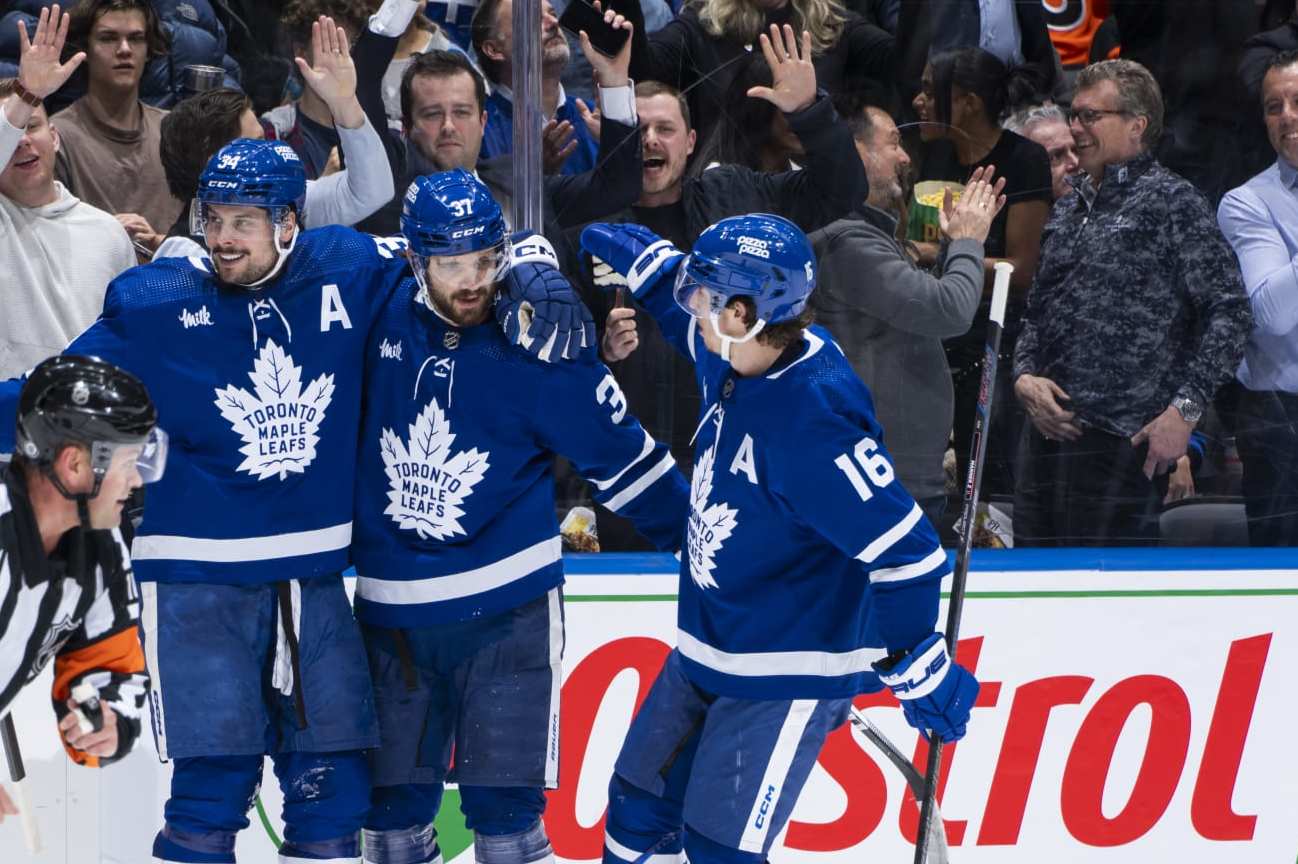 TORONTO, ON - FEBRUARY 15: Auston Matthews #34 of the Toronto Maple Leafs celebrates his third goal of the game against the Philadelphia Flyers with teammates Timothy Liljegren #37 and Mitchell Marner #16 during the second period at Scotiabank Arena on February 15, 2024 in Toronto, Ontario, Canada. (Photo by Kevin Sousa/NHLI via Getty Images)