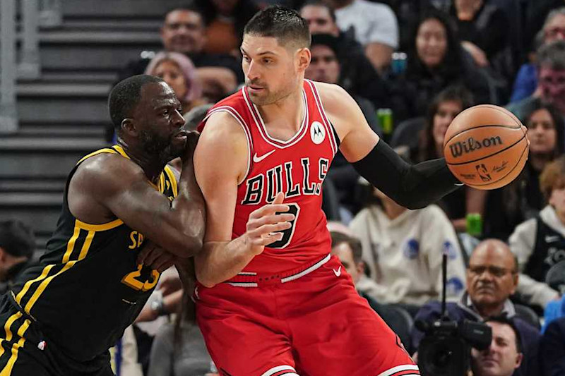 SAN FRANCISCO, CA - MARCH 07: Nikola Vucevic #9 of the Chicago Bulls dribbles the ball in the second quarter against Draymond Green #23 of the Golden State Warriors at Chase Center on March 7, 2024 in San Francisco, California. NOTE TO USER: User expressly acknowledges and agrees that, by downloading and/or using this photograph, User is consenting to the terms and conditions of the Getty Images License Agreement. (Photo by Kavin Mistry/Getty Images)